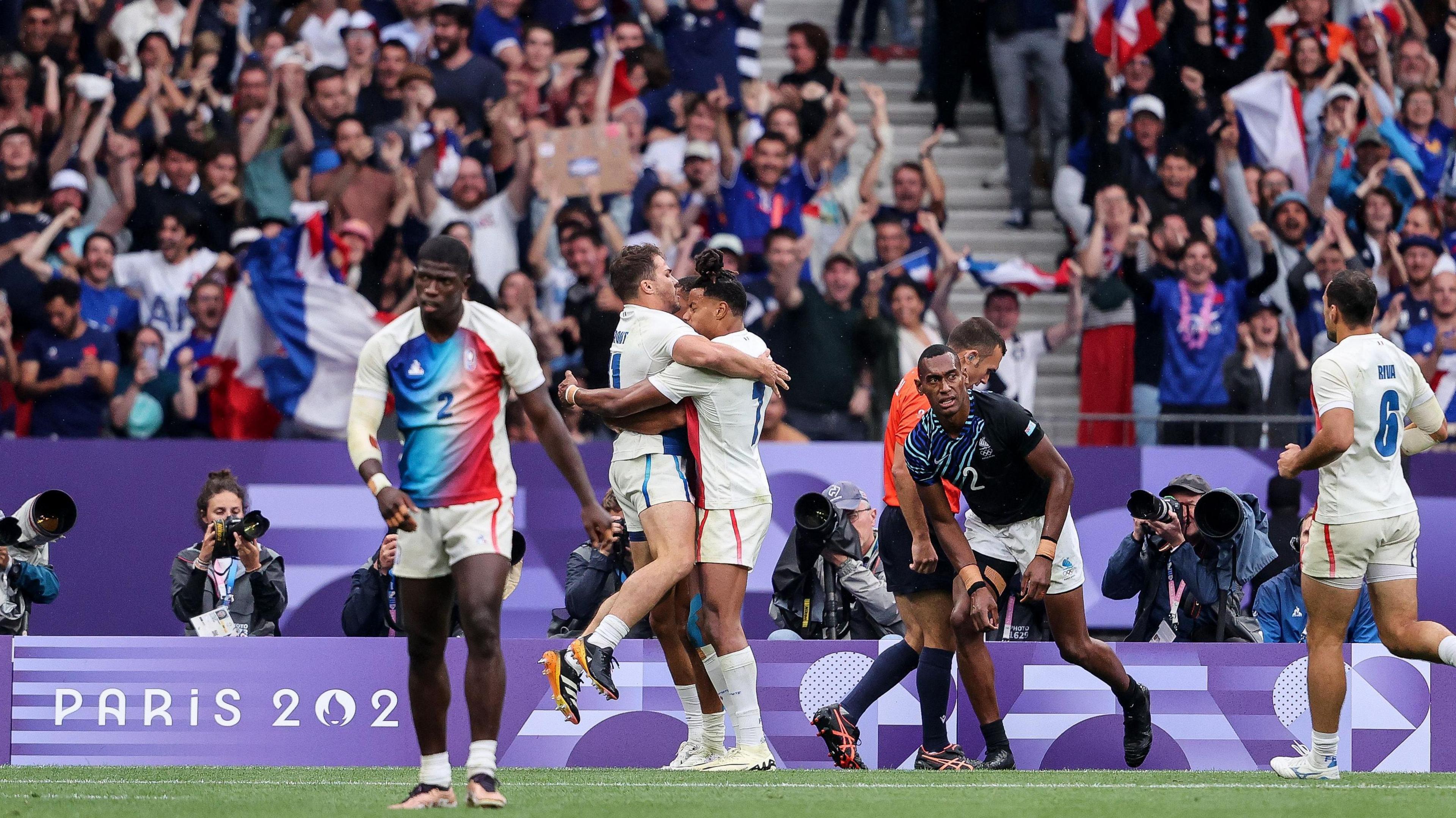 Antoine Dupont congratulates Aaron Grandidier Nkanang after his try against Fiji