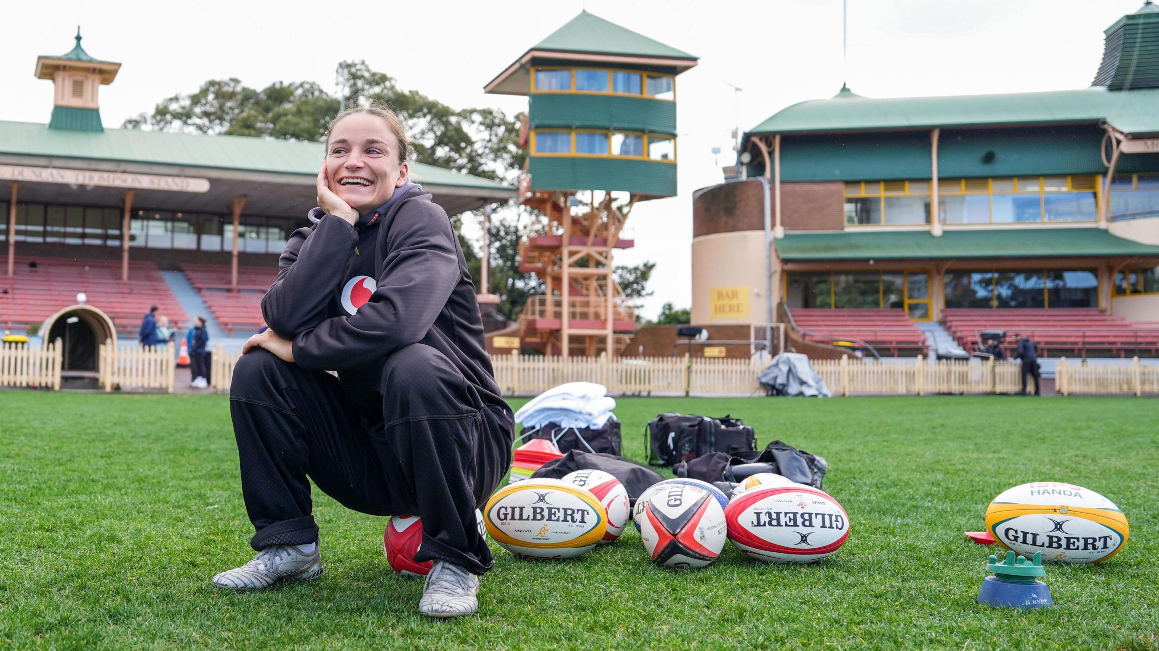 Jasmine Joyce-Butchers smiling while sitting connected a shot successful training