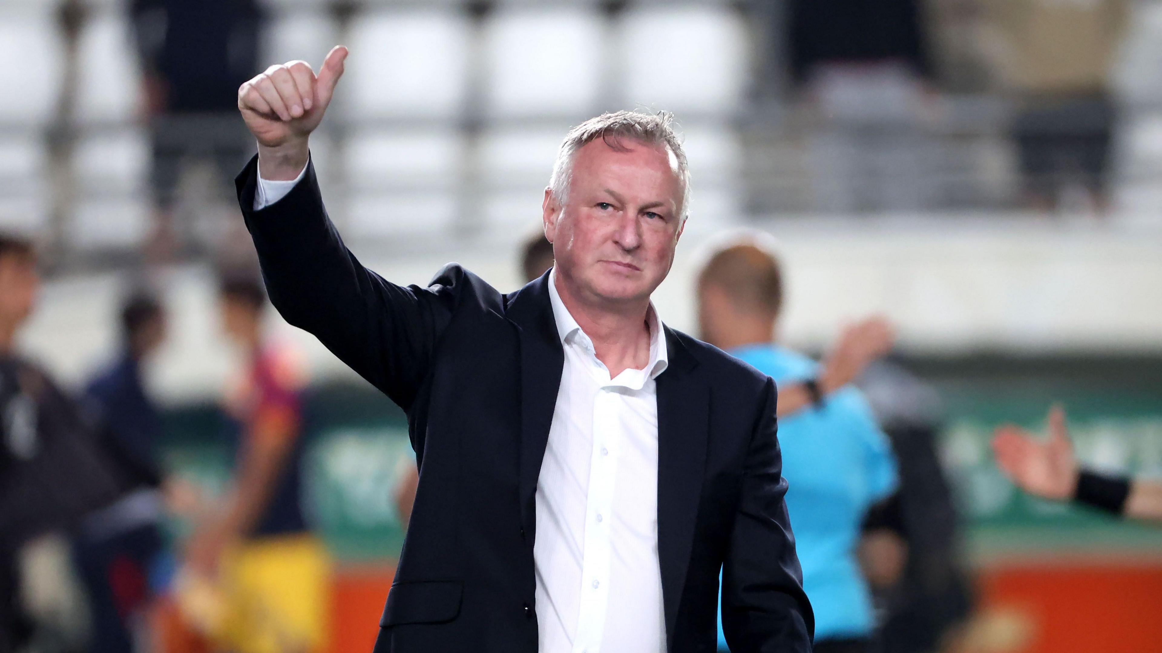 Michael O'Neill salutes the travelling support