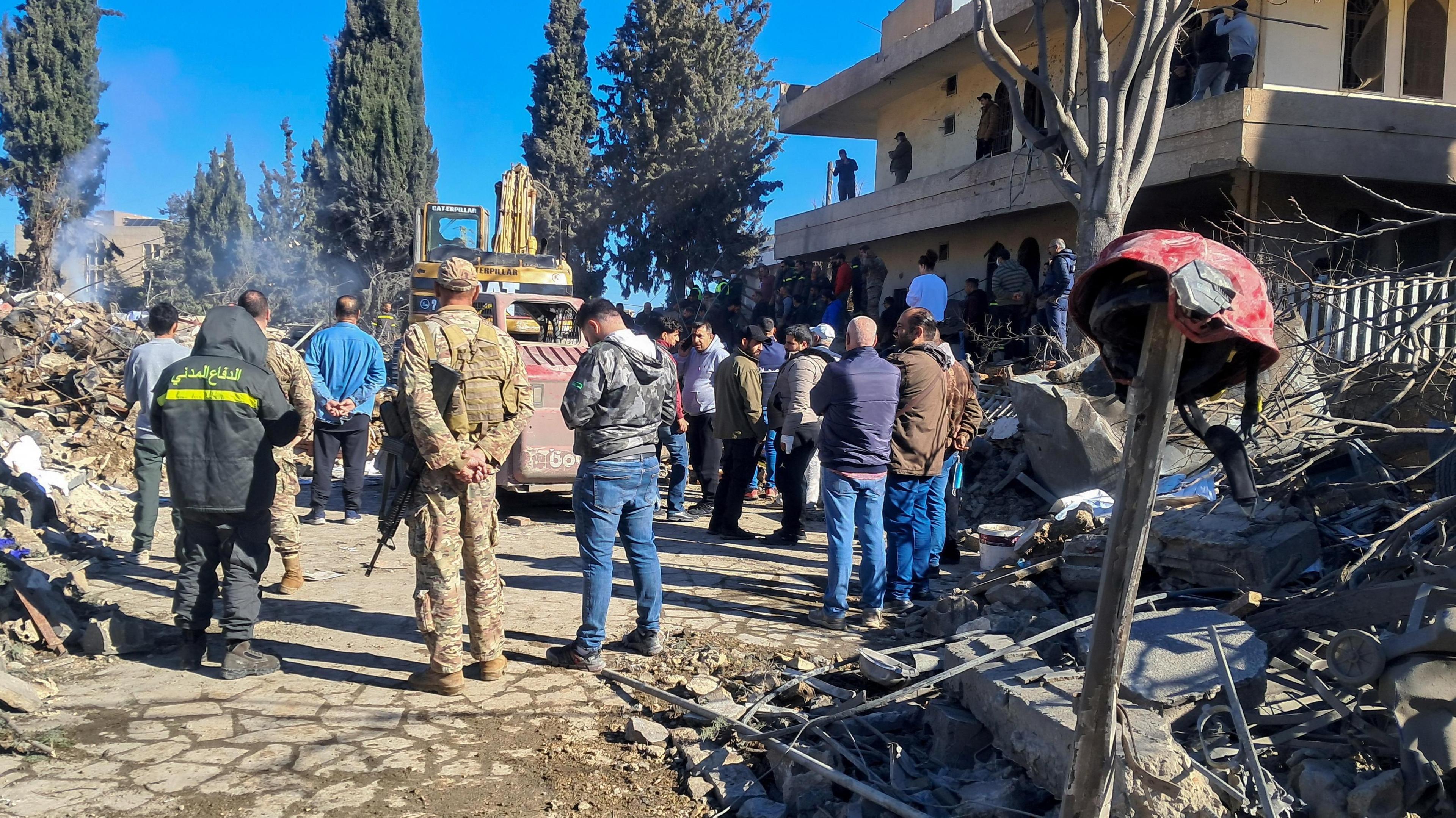 People and emergency workers gathered outside the site of an Israeli air strike at an emergency response centre