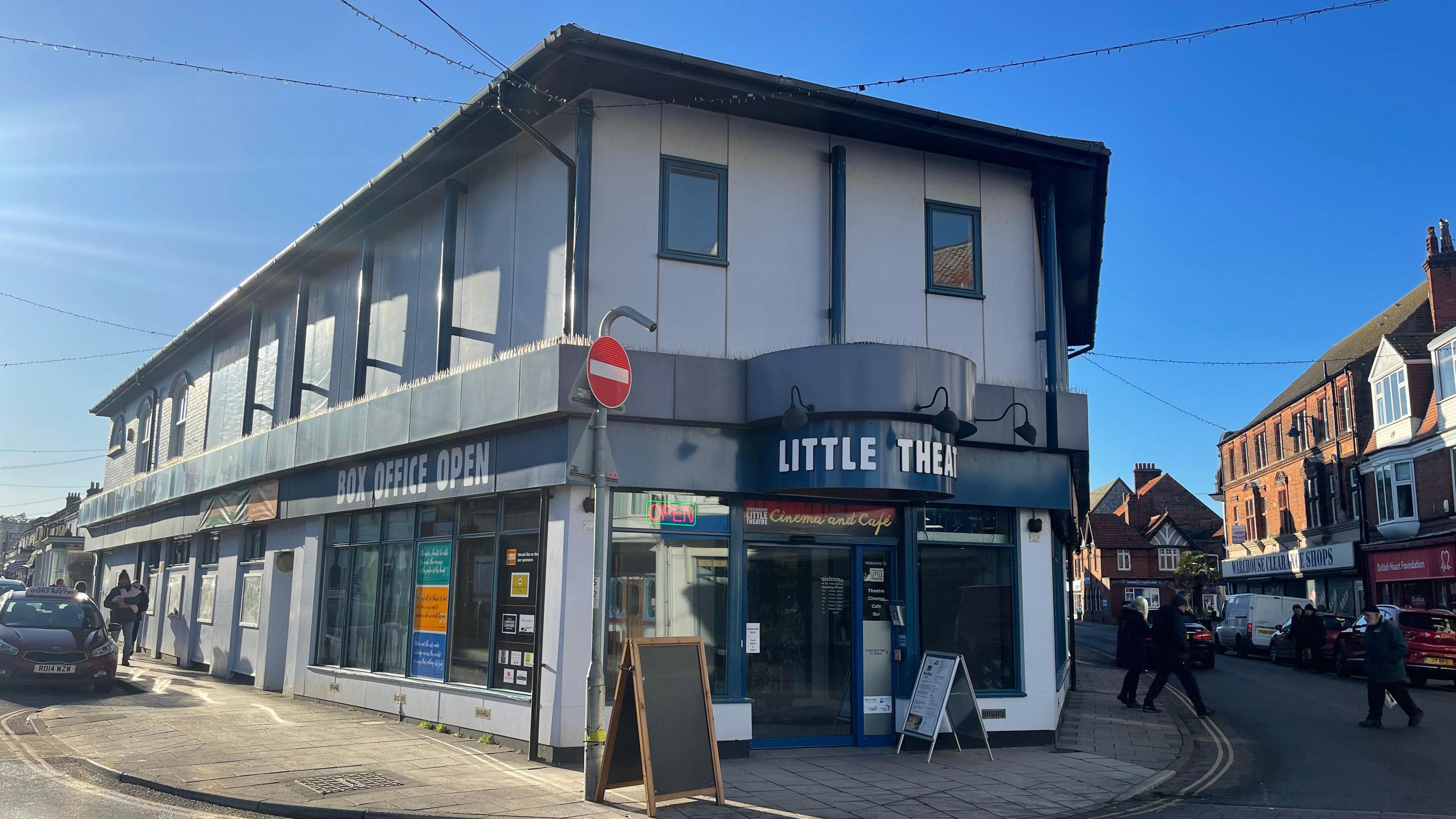 Sheringham Little Theatre, a grey and blue building on the corner of two streets