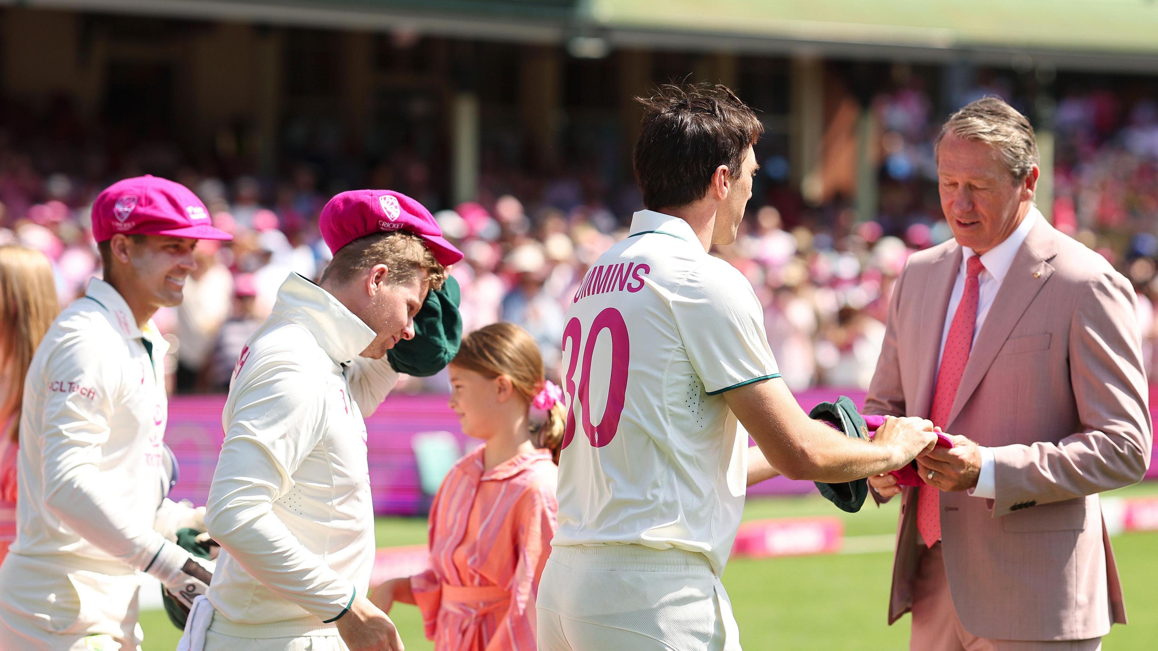 Glenn McGrath takes pink caps from Australia players before Pink Test in 2025