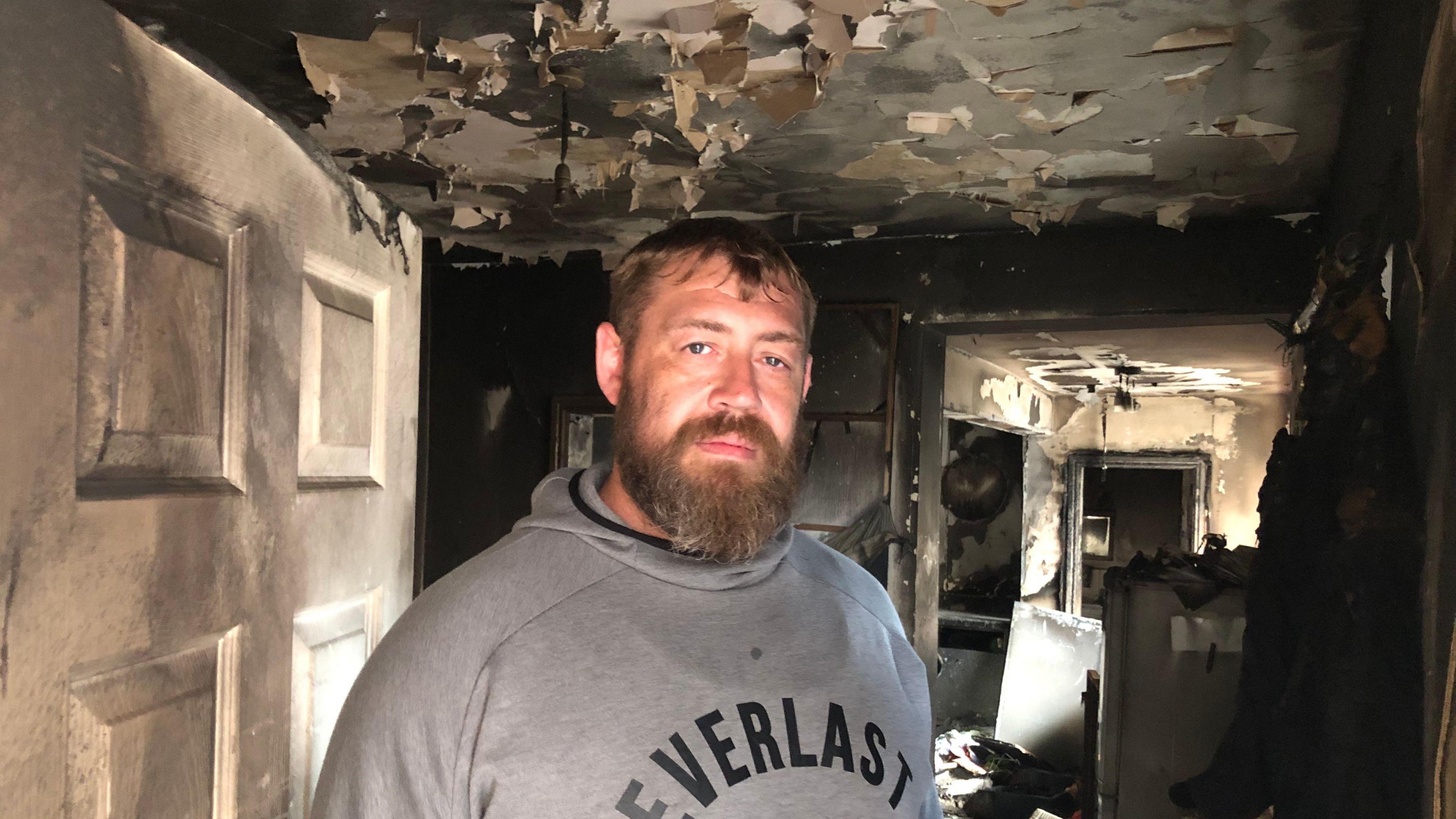 Simon Blanshard in his fire damaged home