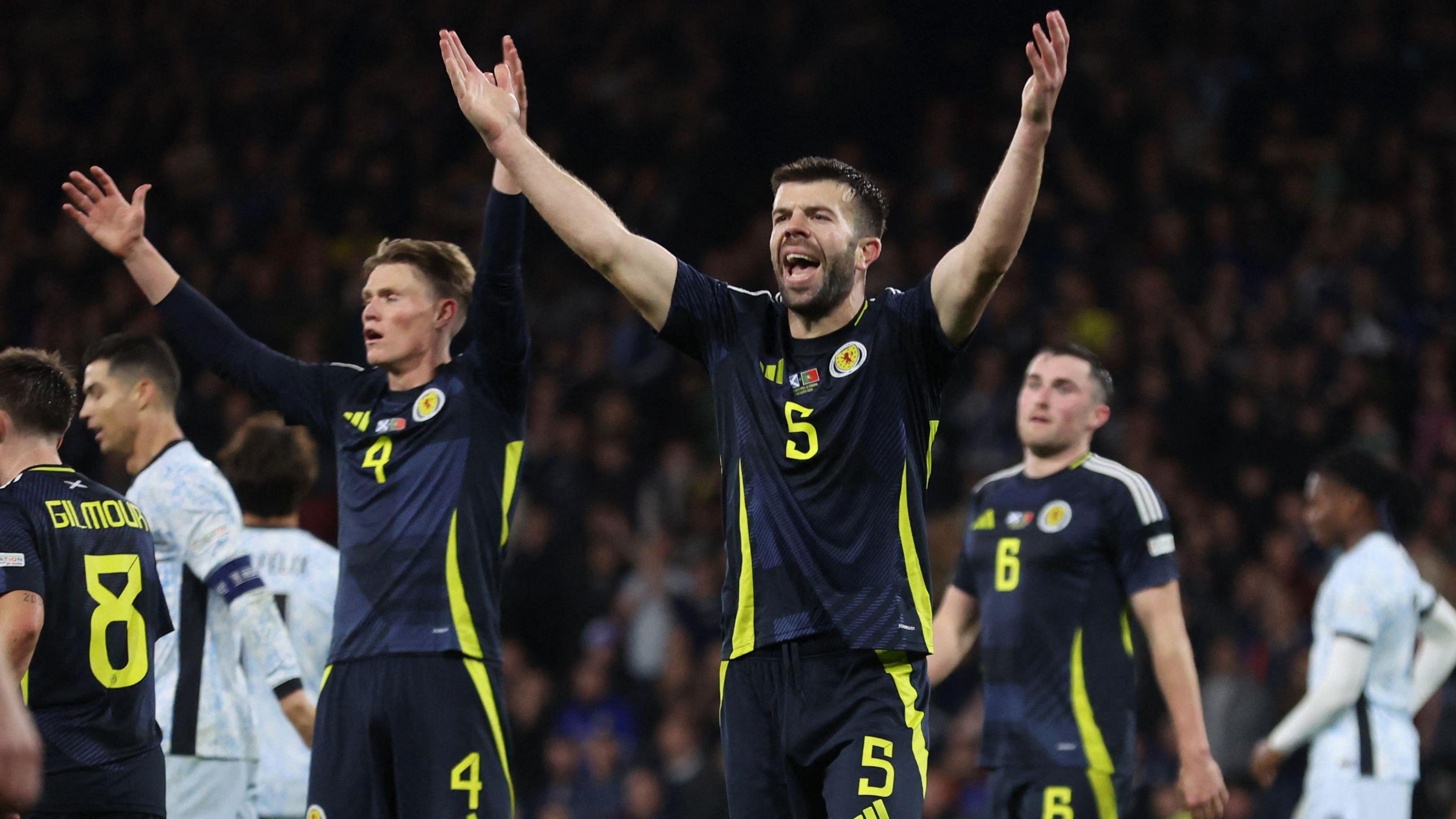 Scotland's Grant Hanley cheers with fans after Scotland's game against Portugal