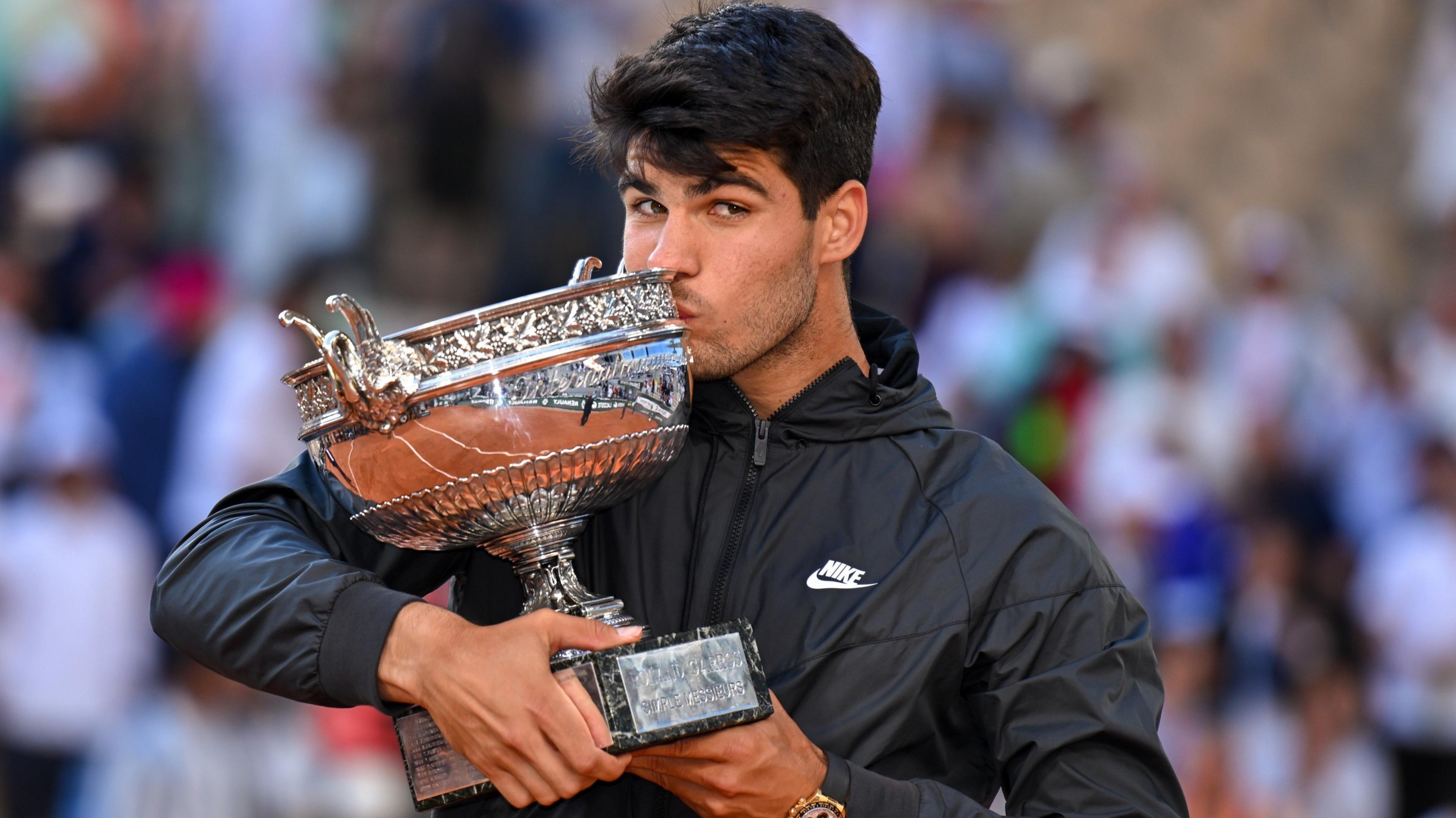 Carlos Alcaraz kisses the French Open trophy after his victory in the men's singles final in 2024