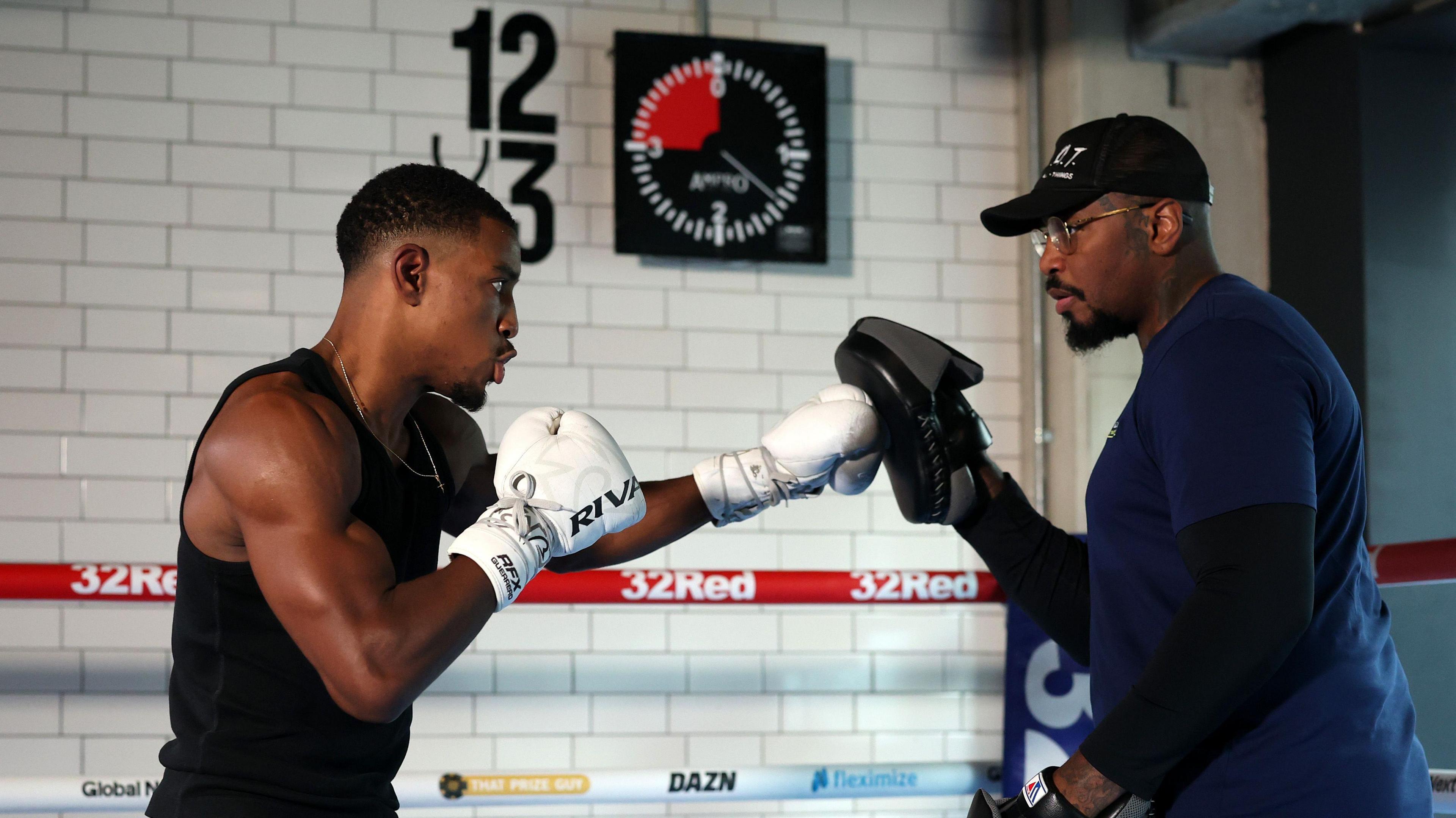 Ezra Taylor hits the pads with trainer Malik Scott