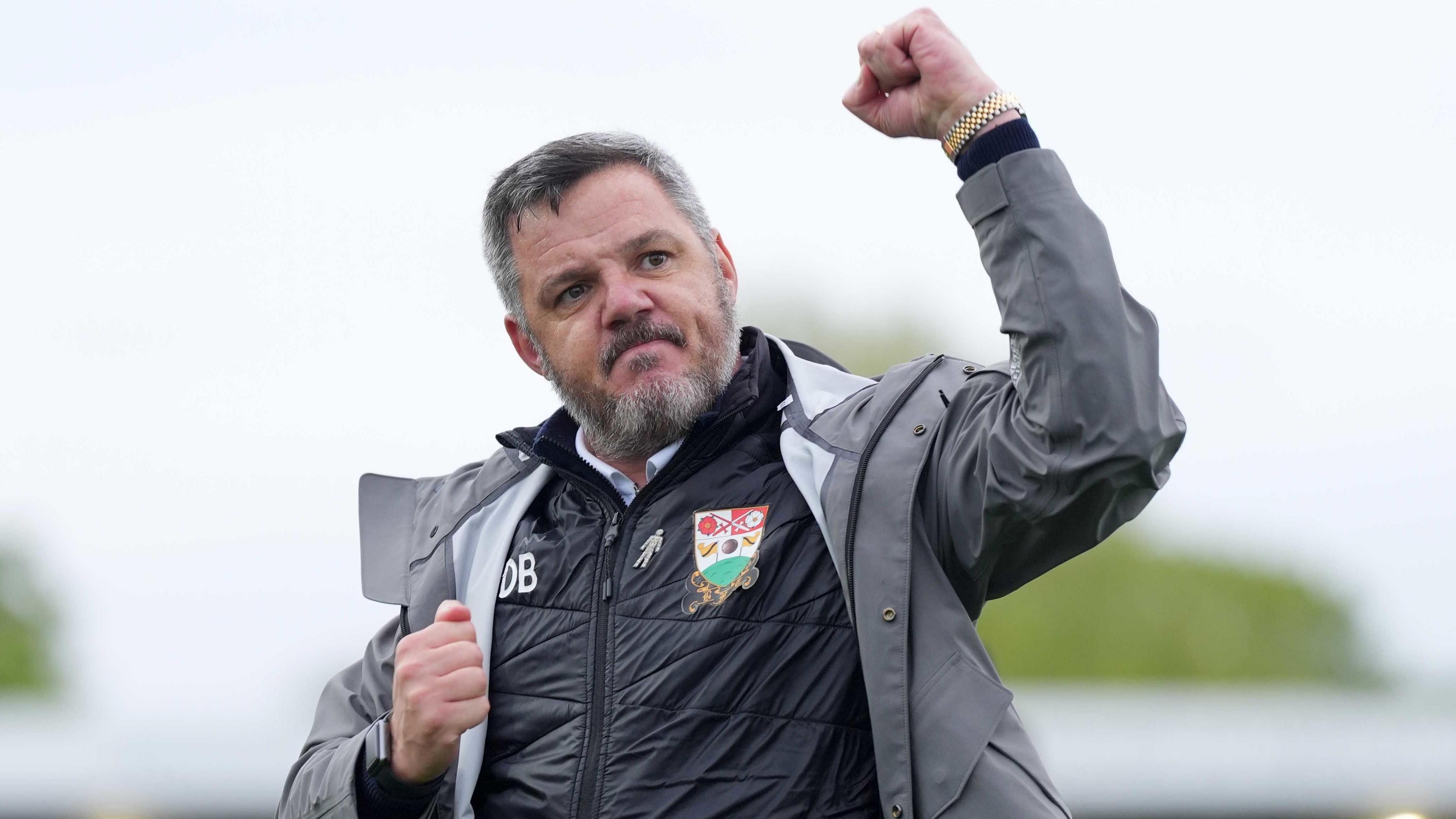 Barnet boss Dean Brennan punches the air in celebration