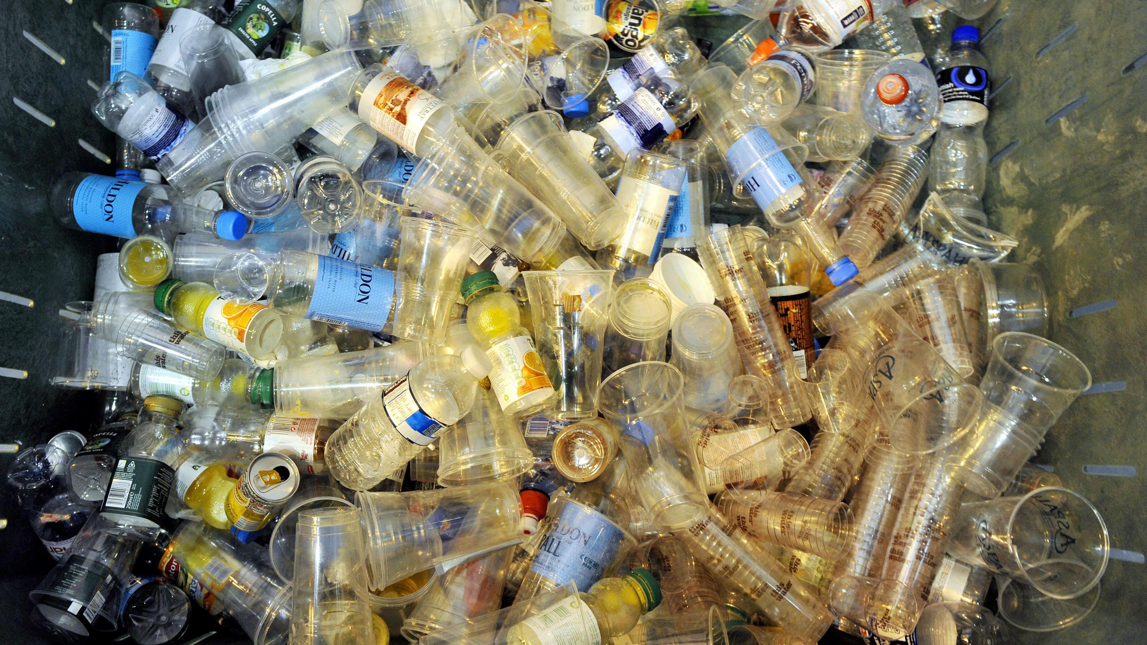 Lots of empty plastic bottles and cups in the bin.