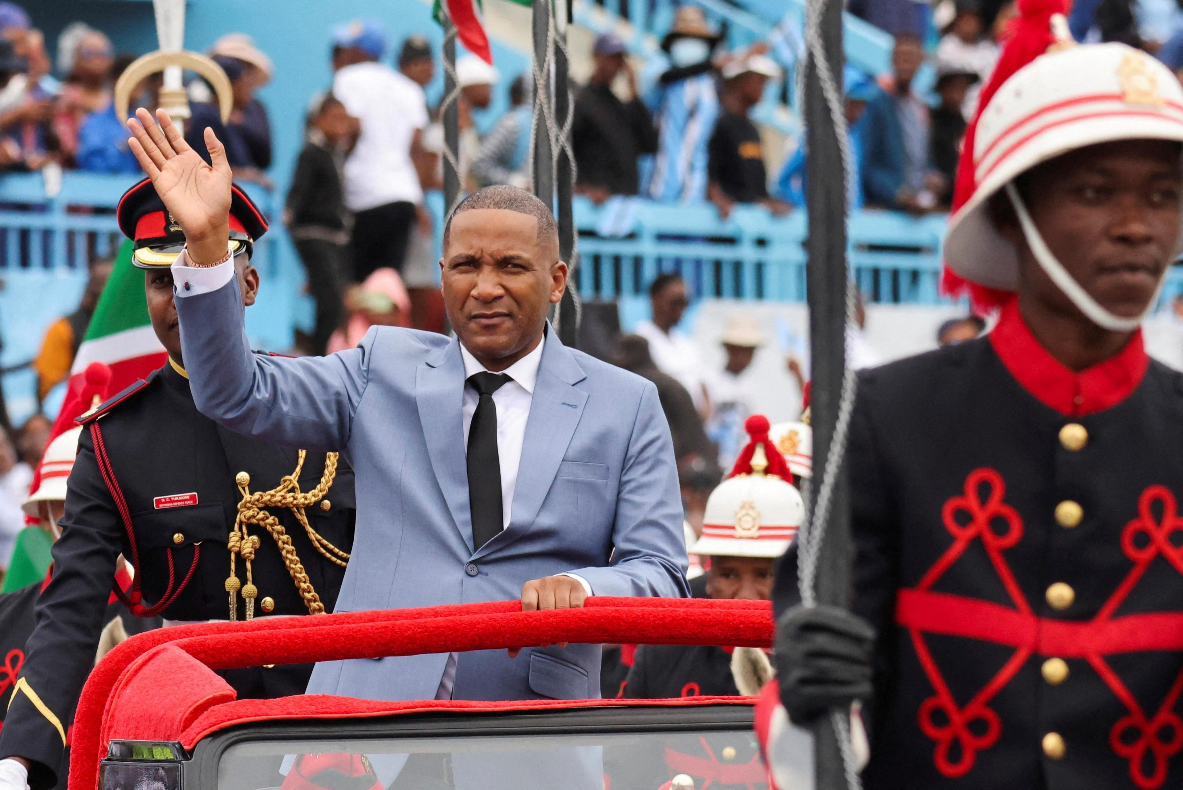 Duma Boko waves to supporters from a car during the ceremony.