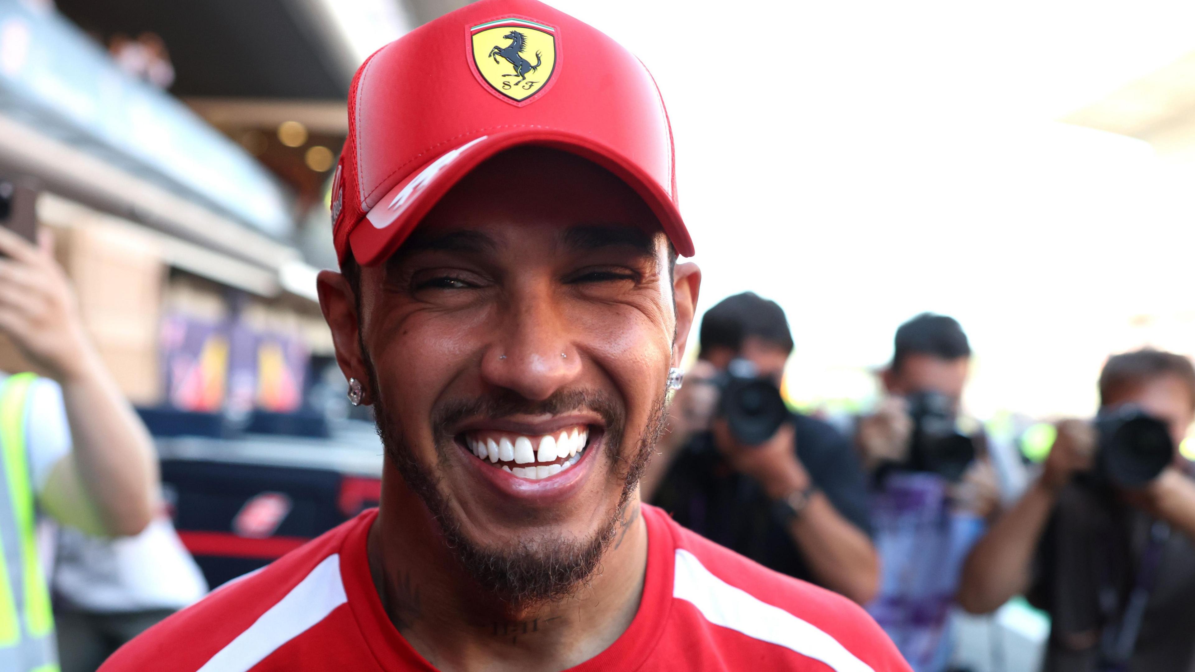 Lewis Hamilton smiles while celebrating his victory for Ferrari in the Barcelona-Catalunya Grand Prix