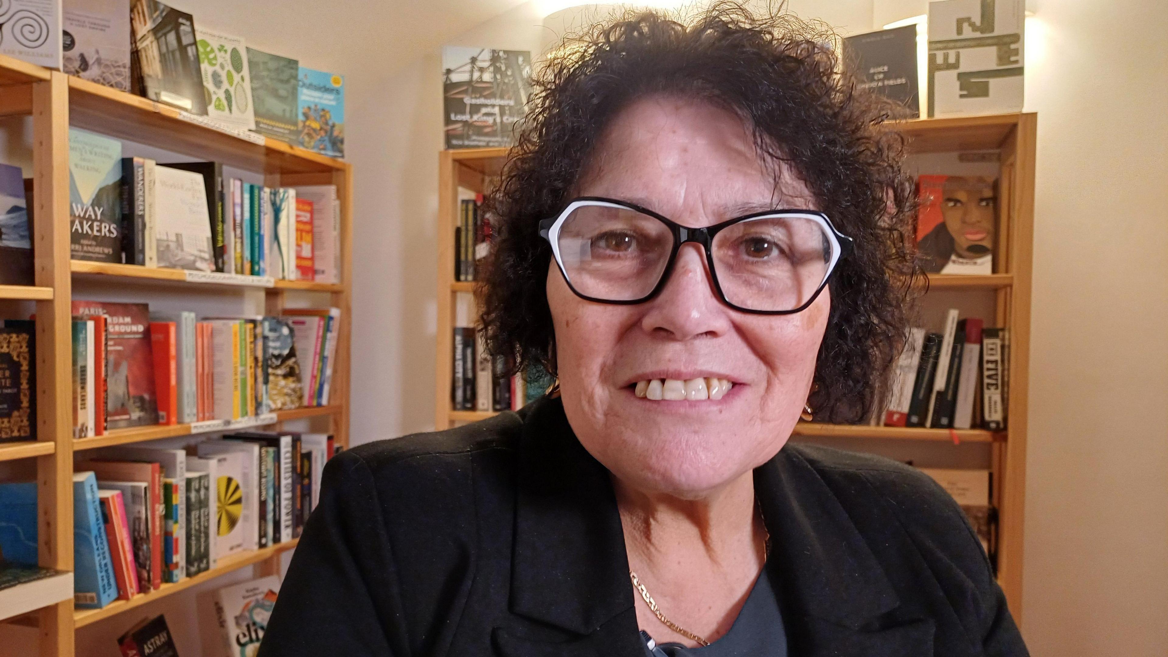 Sian James in front of bookshelves at the King's Cross meet-up