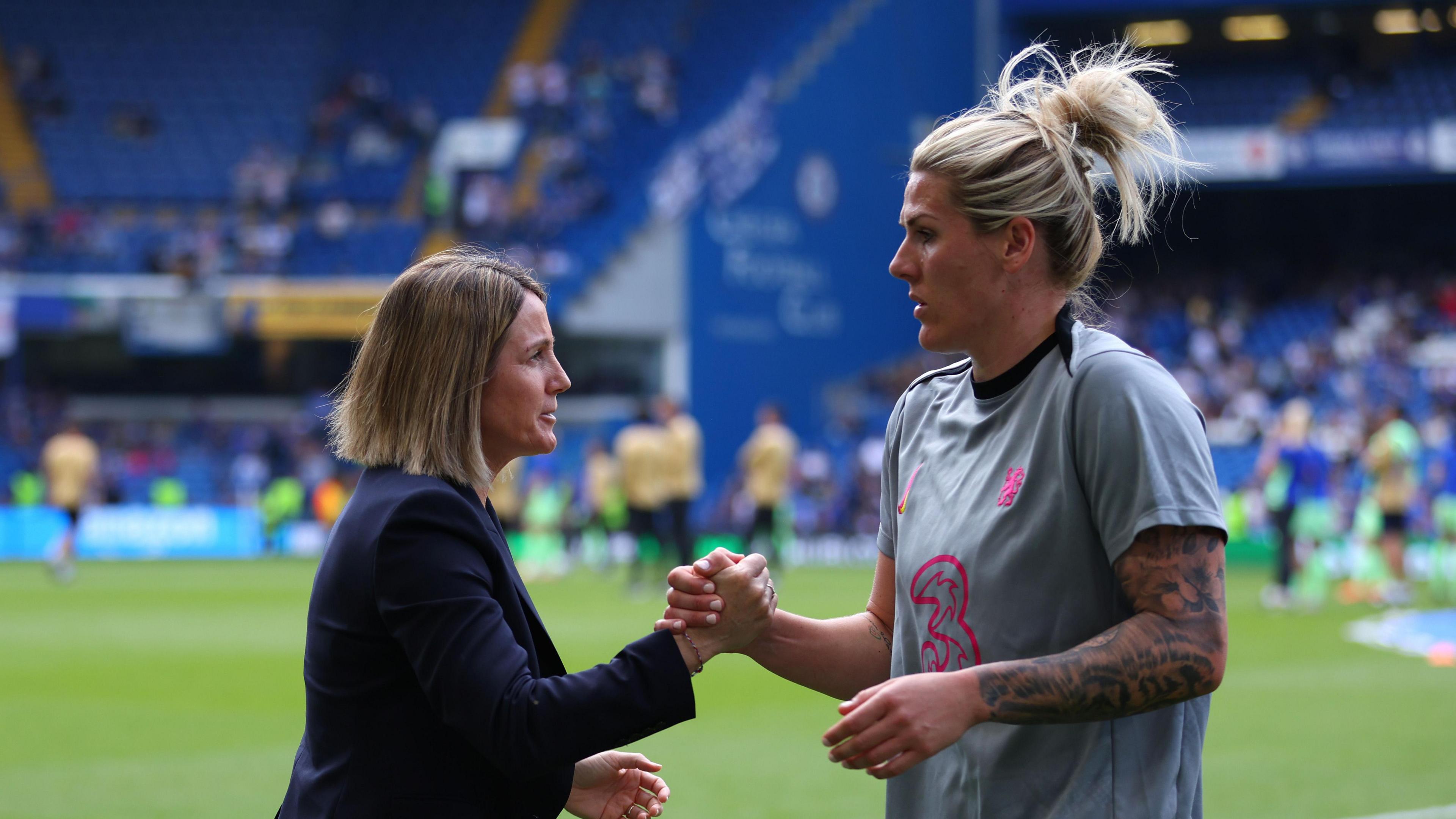 Sonia Bompastor shakes hands with Millie Bright