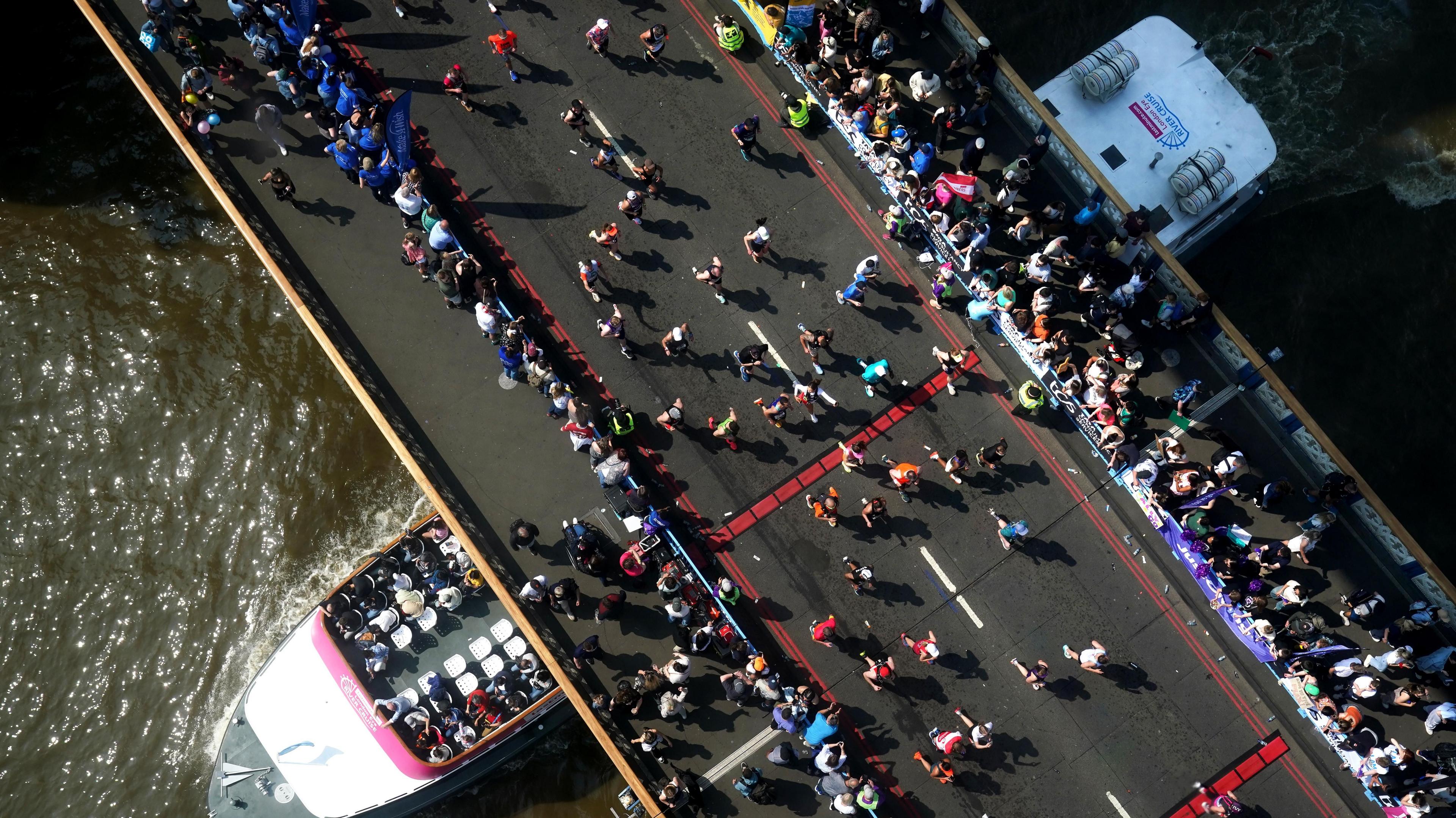 runners seen from above crossing Tower Bridge 