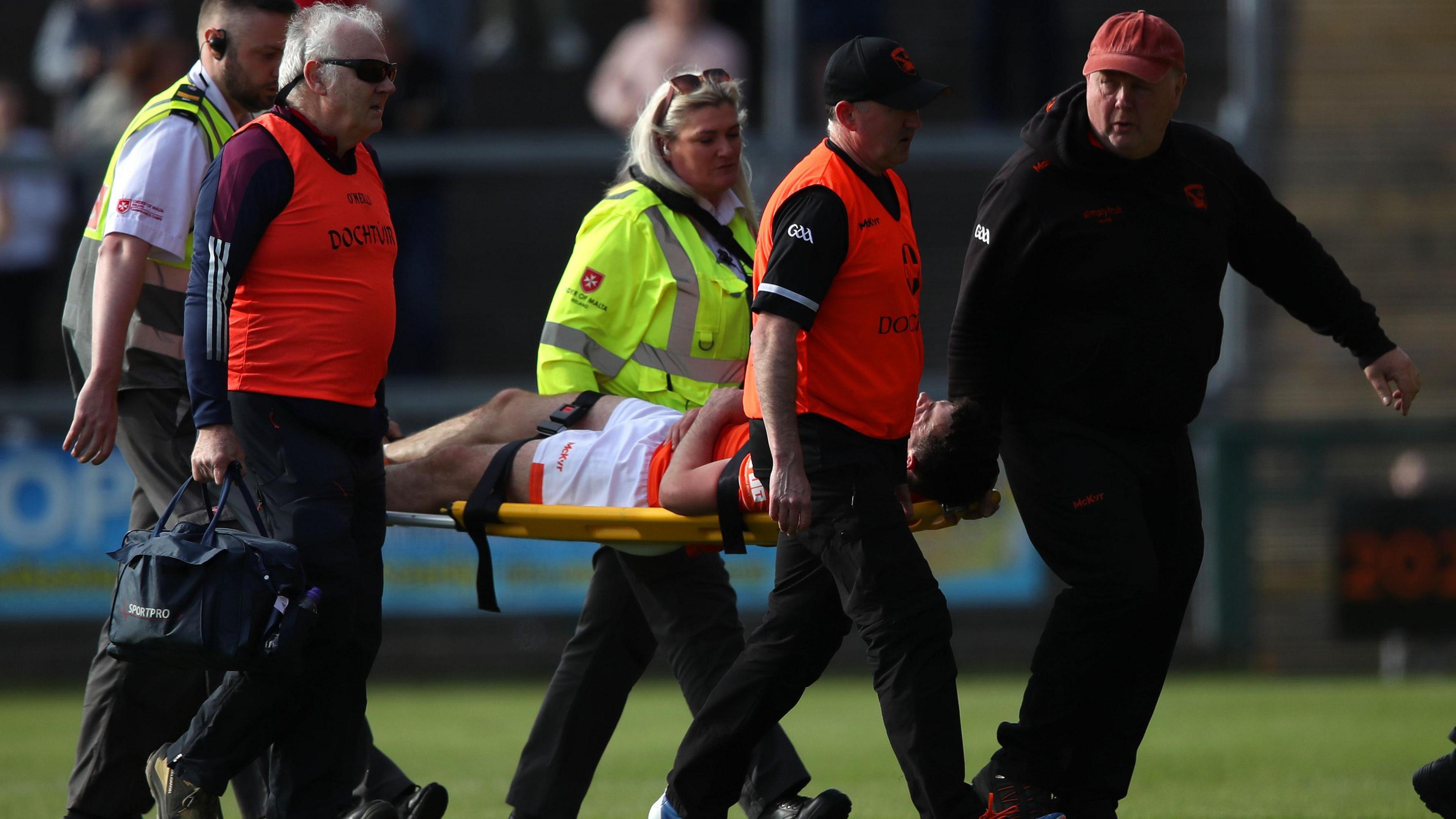 Conor O'Neill is stretchered off