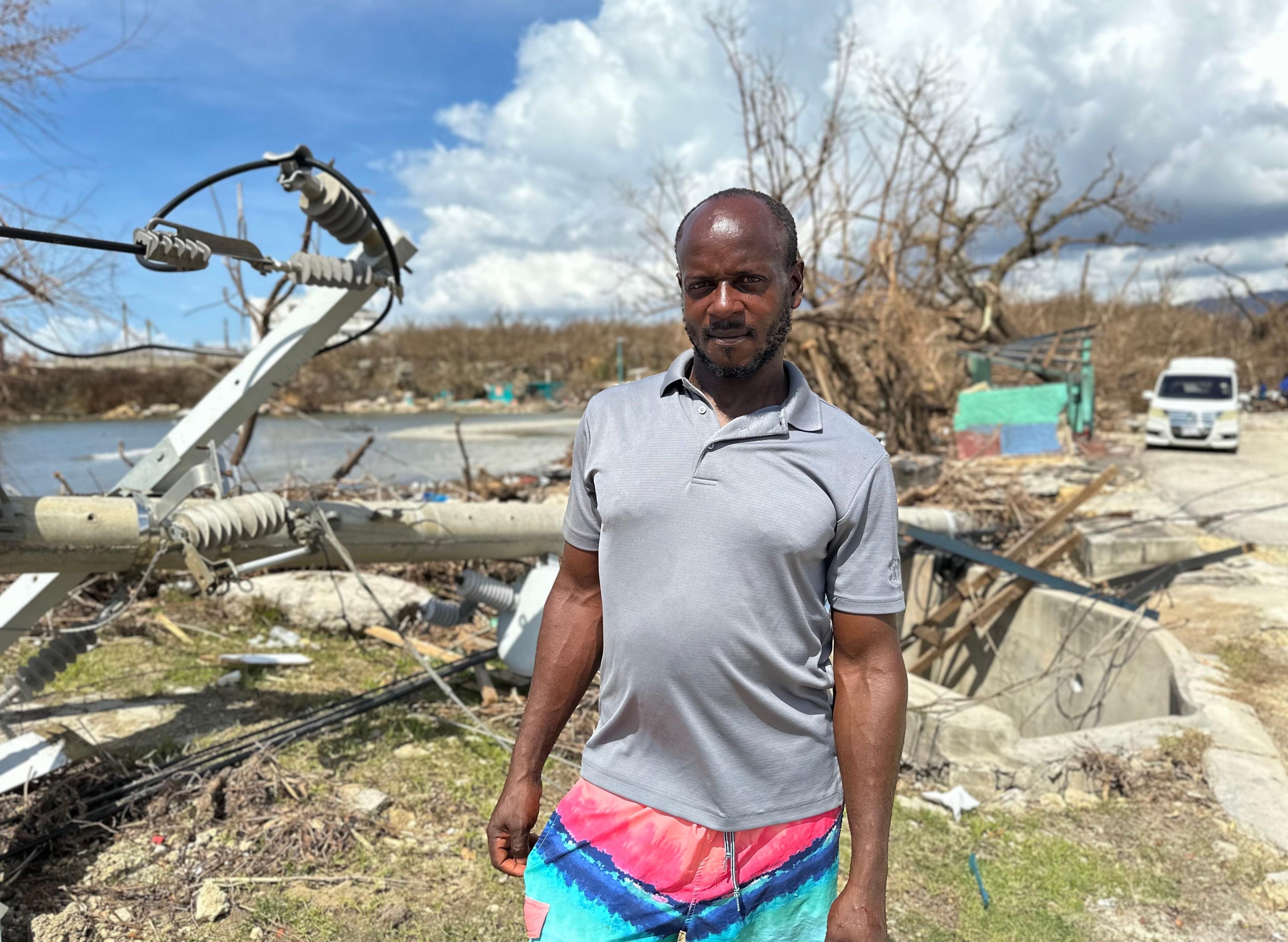 Robert Morris stands in front of his fishing village that was flattened by Hurricane Melissa