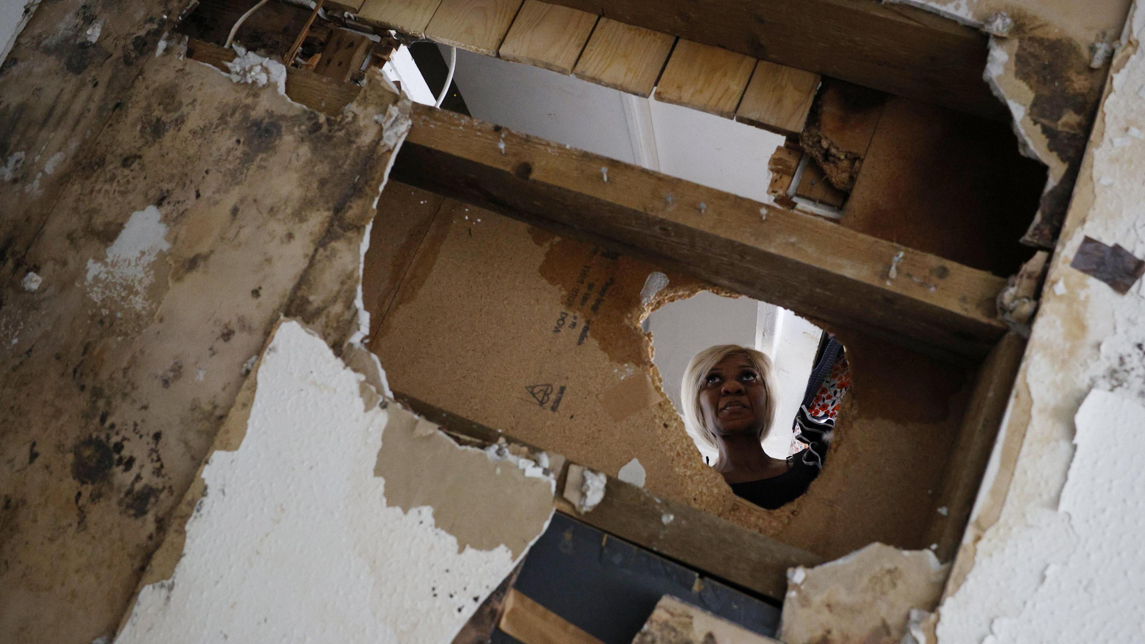 Close up image of hole with the owner, Sacha Berko, standing on top looking through it. 