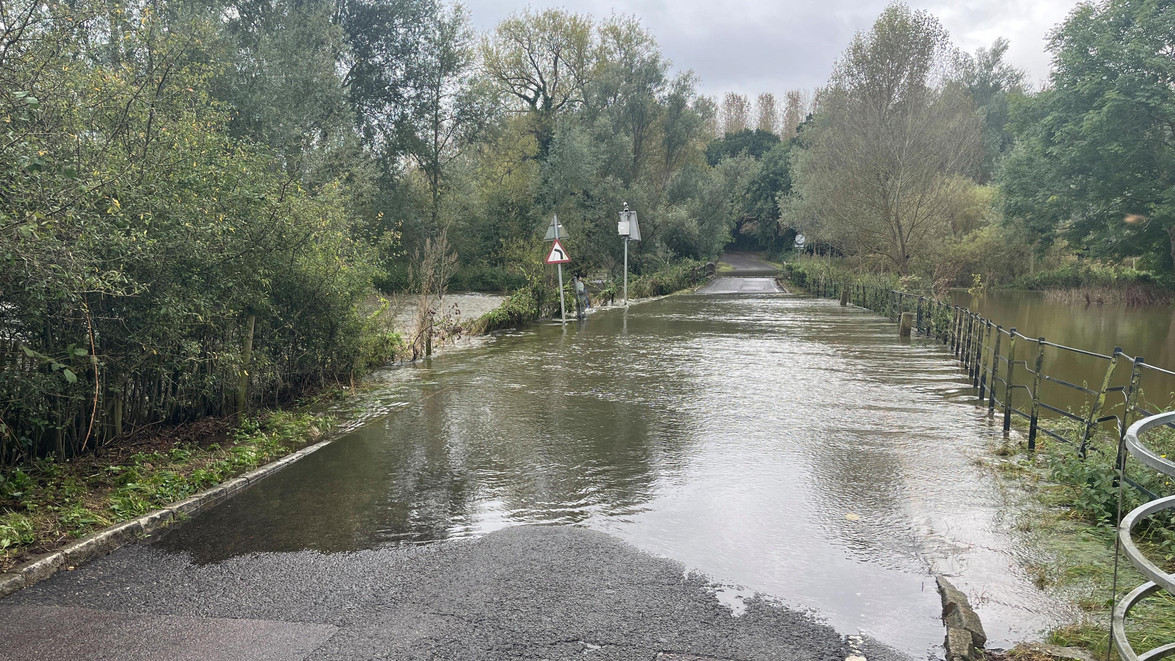 A large pool of water stretches over a bridge as far as the eye can see.