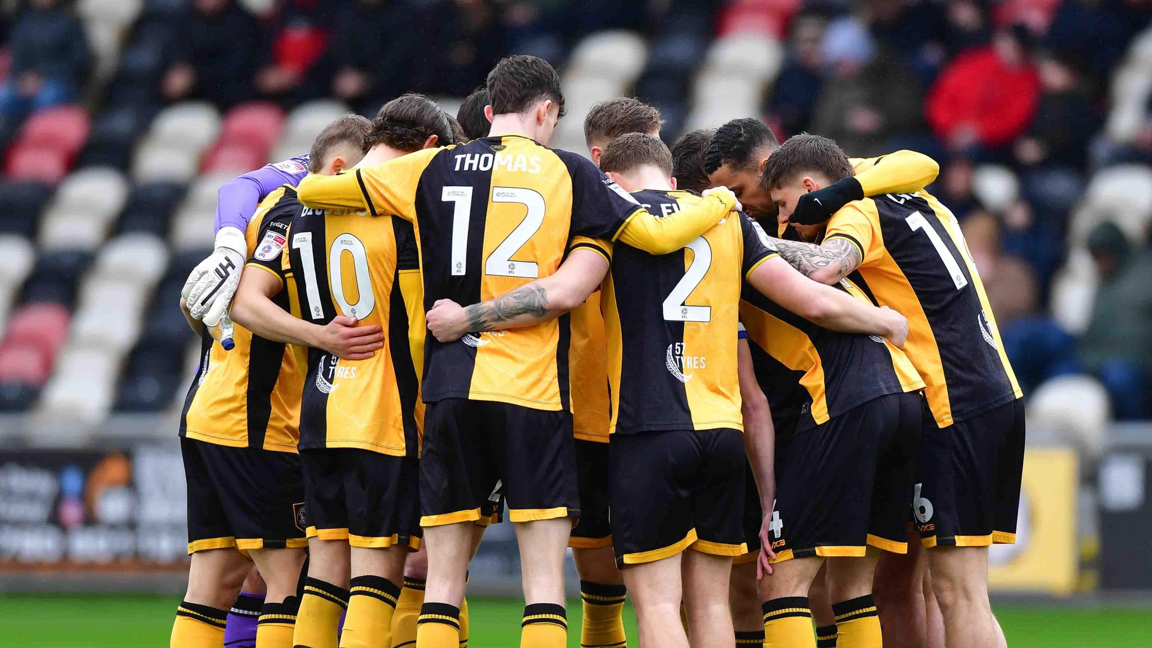 Newport County players in a group huddle
