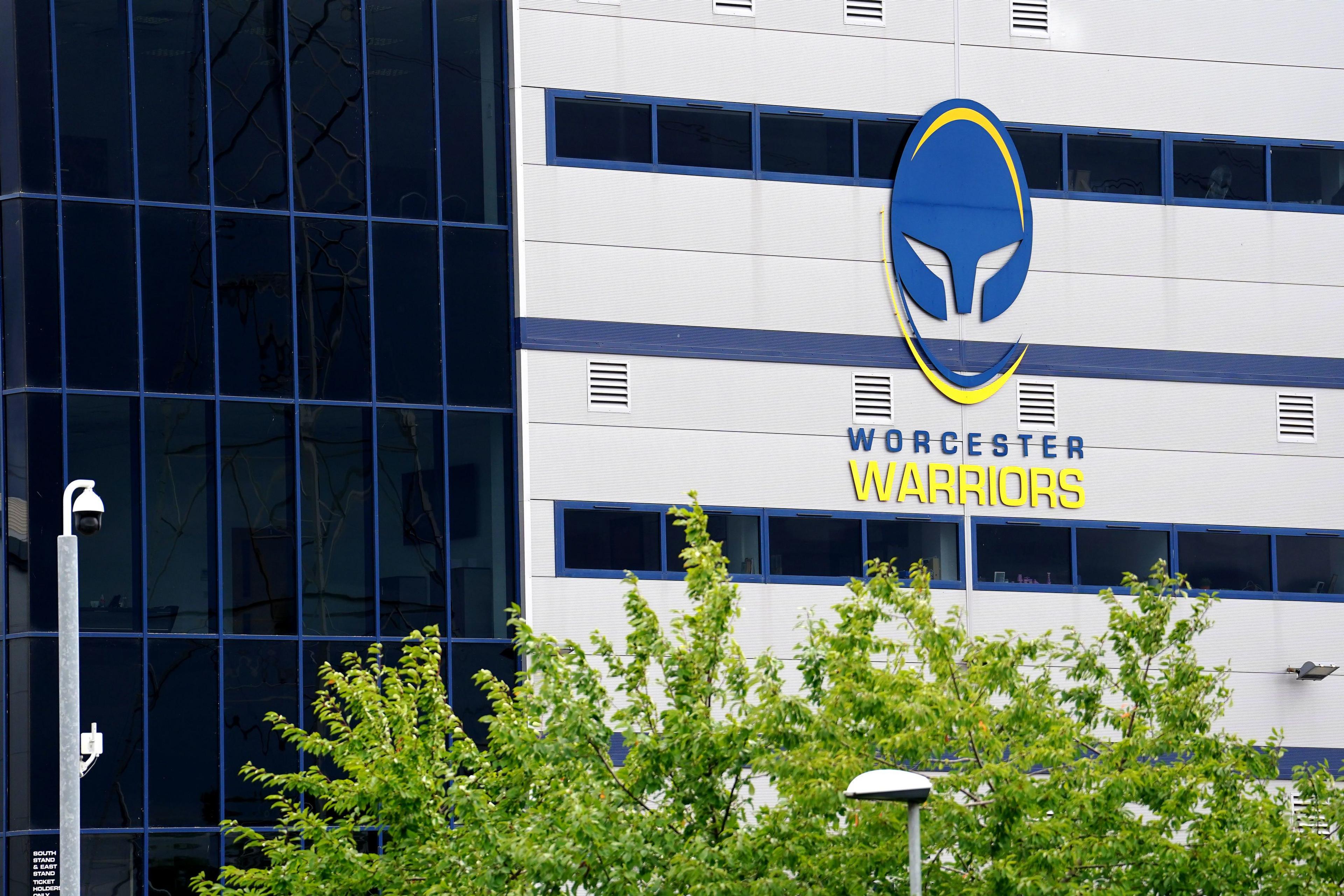 A rugby stadium, showing a large blue and yellow logo with the words 'Worcester WARRIORS'.
