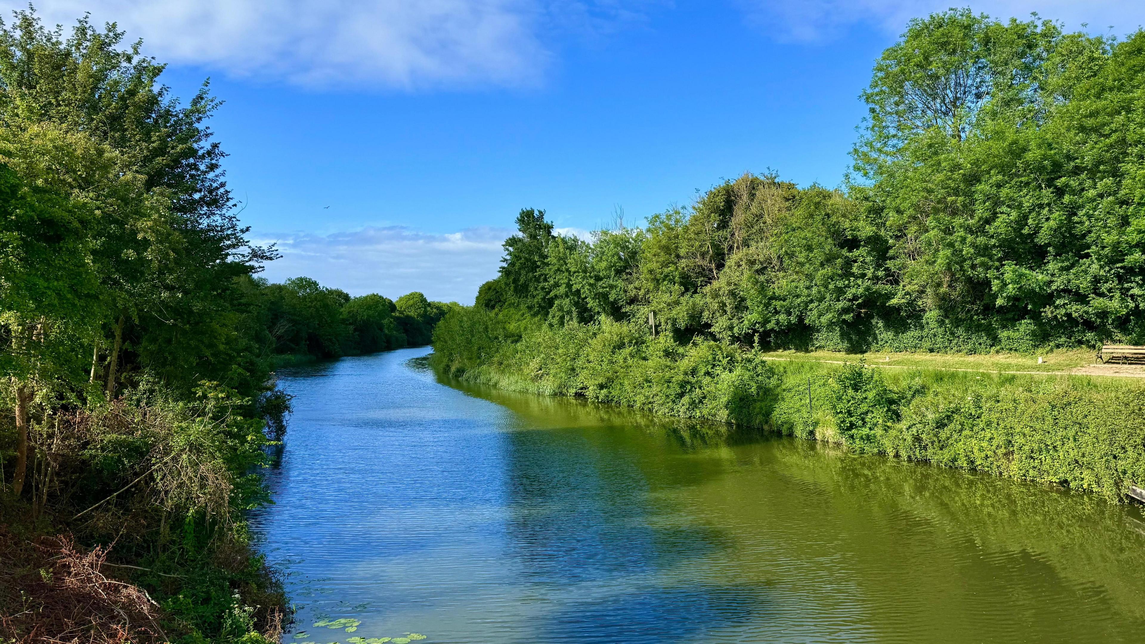 A river in the middle of the photo with greenery either side in Gloucestershire