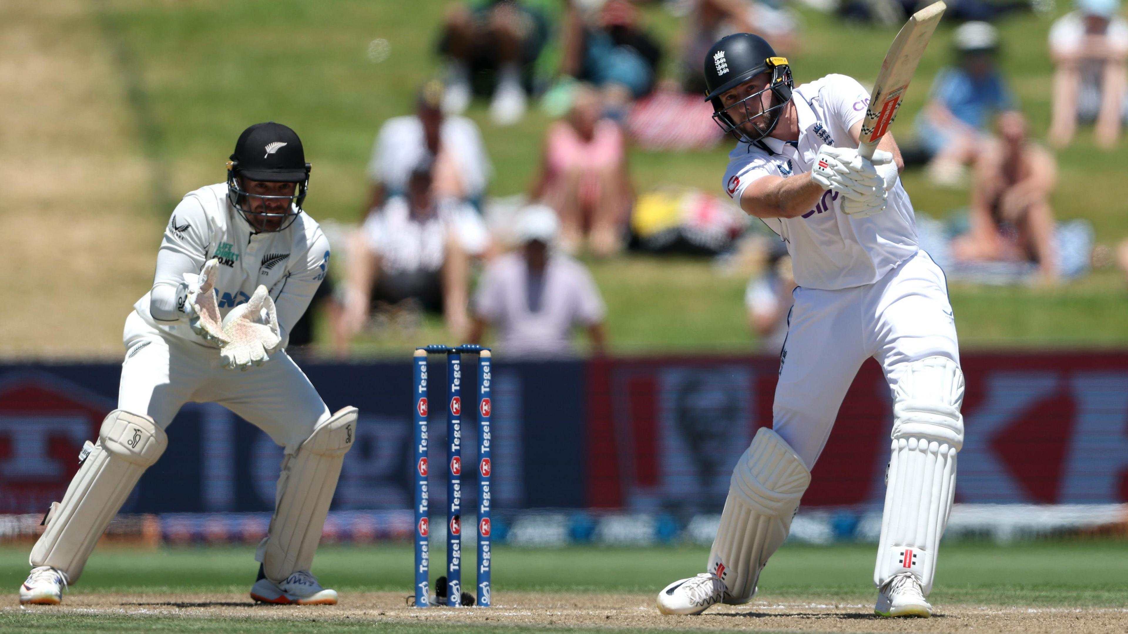 England's Gus Atkinson hits out, watched by New Zealand wicketkeeper Tom Blundell, in 2024