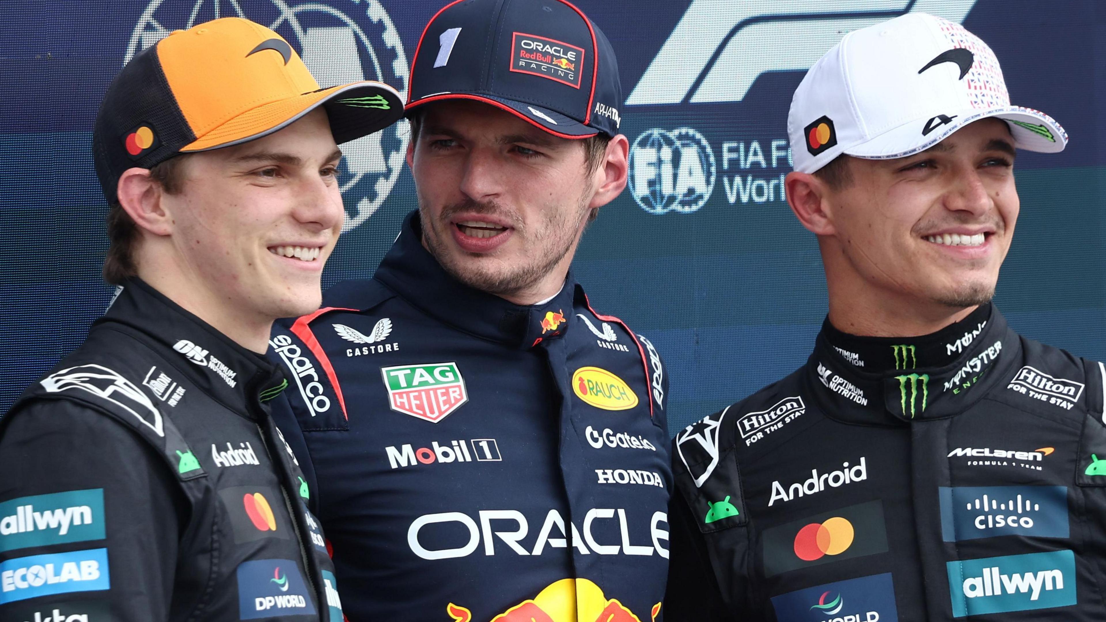 Oscar Piastri, Max Verstappen and Lando Norris - the top three - pose for pictures after qualifying for the British Grand Prix at Silverstone