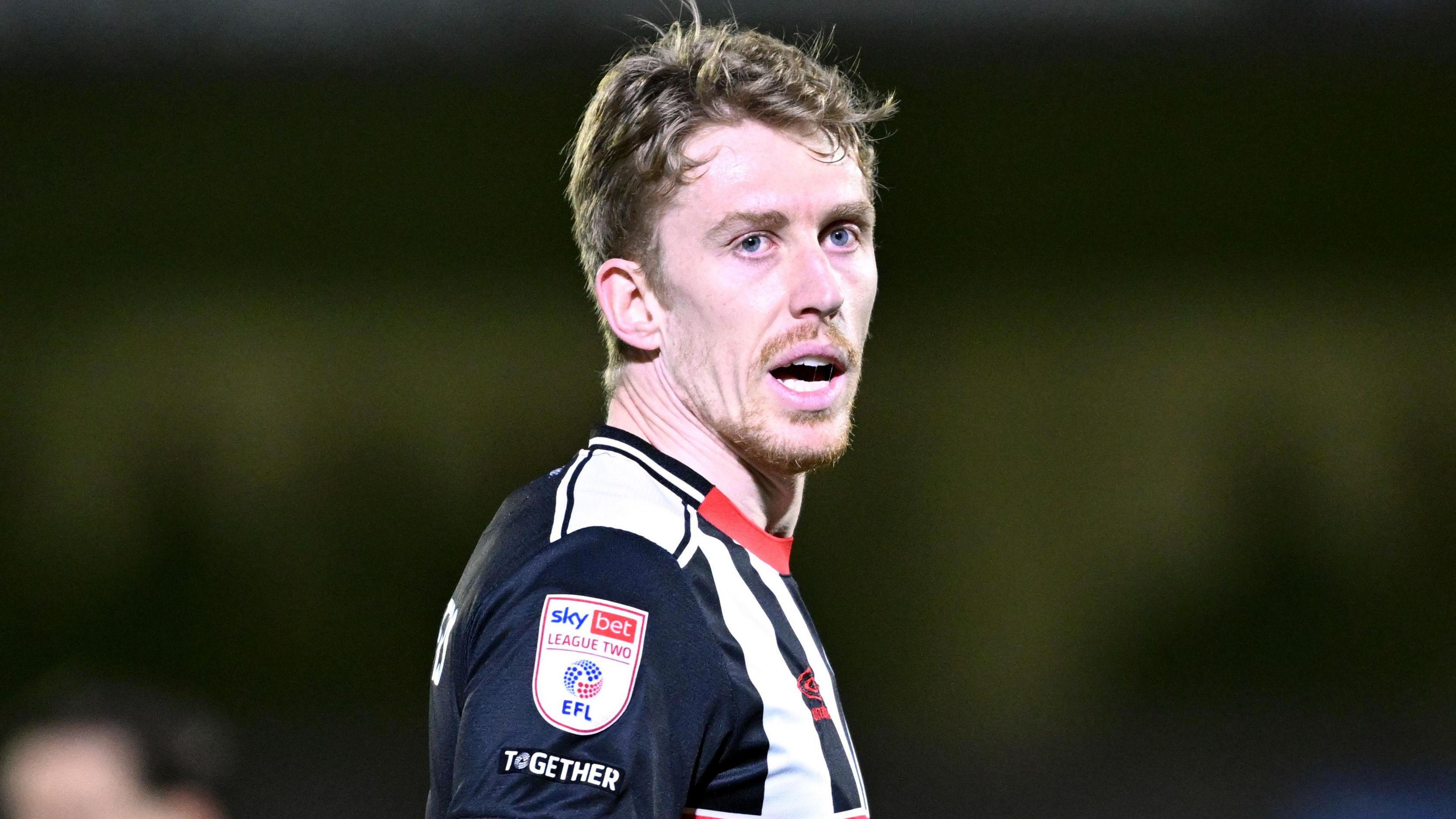 Harvey Rodgers with his mouth slightly open while wearing the black and white Grimsby jersey during the 1-0 home win over Fleetwood on 17 March