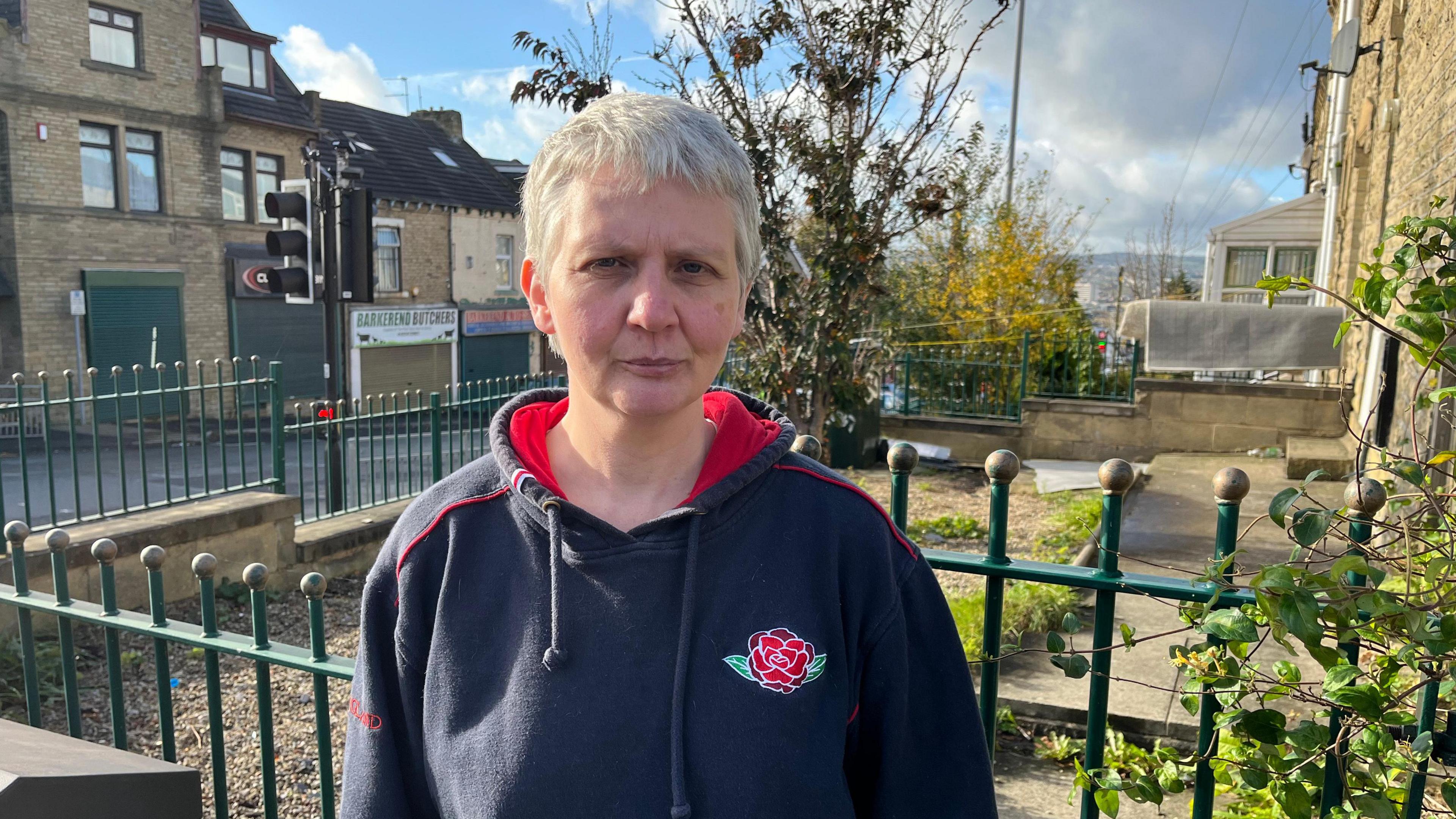 Anne Dunn has short white hair and is wearing a navy blue England Rugby hoody.