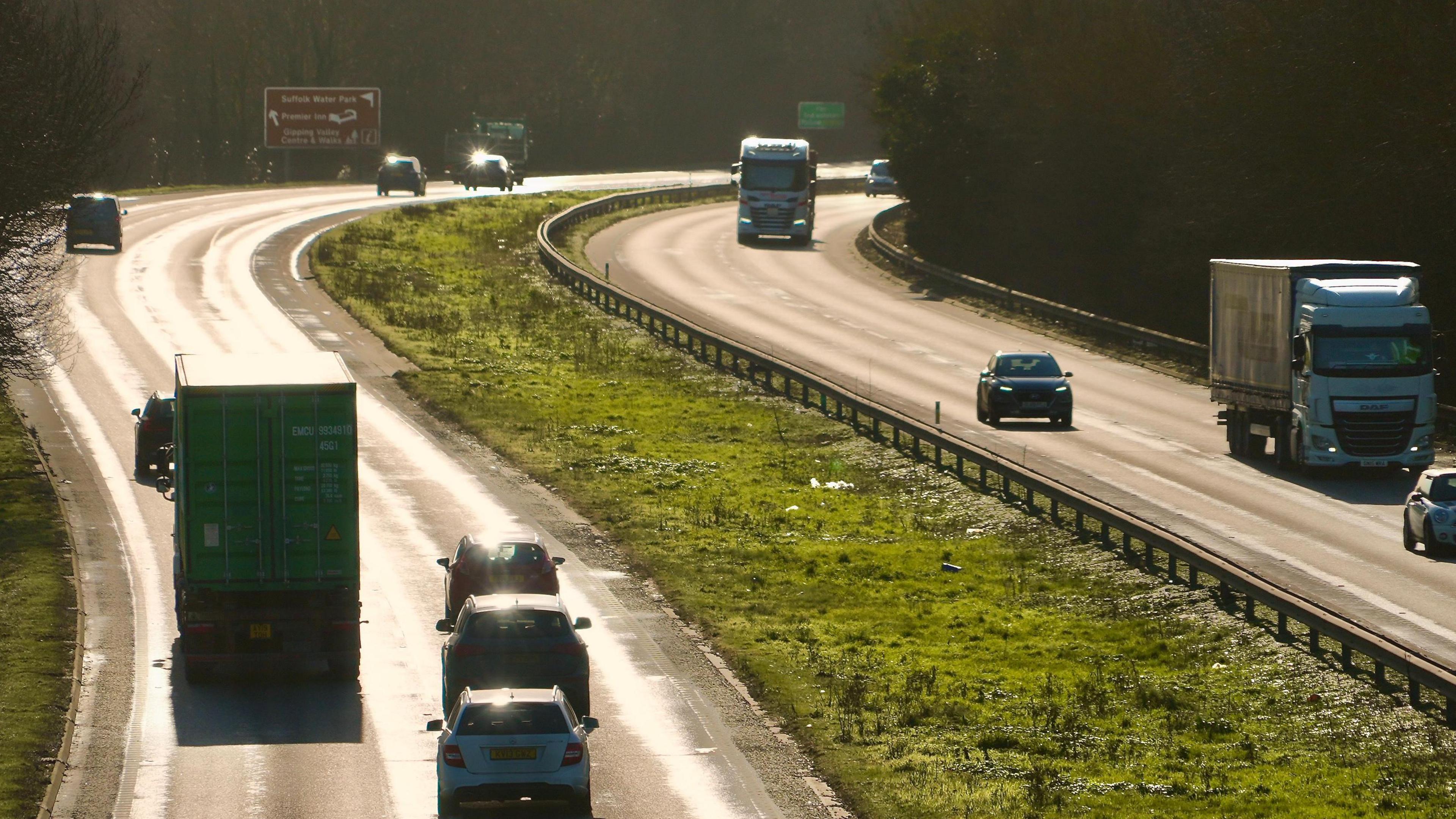 A general view of the A14 carriageway close to Ipswich on a sunny day. The photo has been taken from a bridge above the carriageway. Vehicles can be seen travelling along each side of the road.