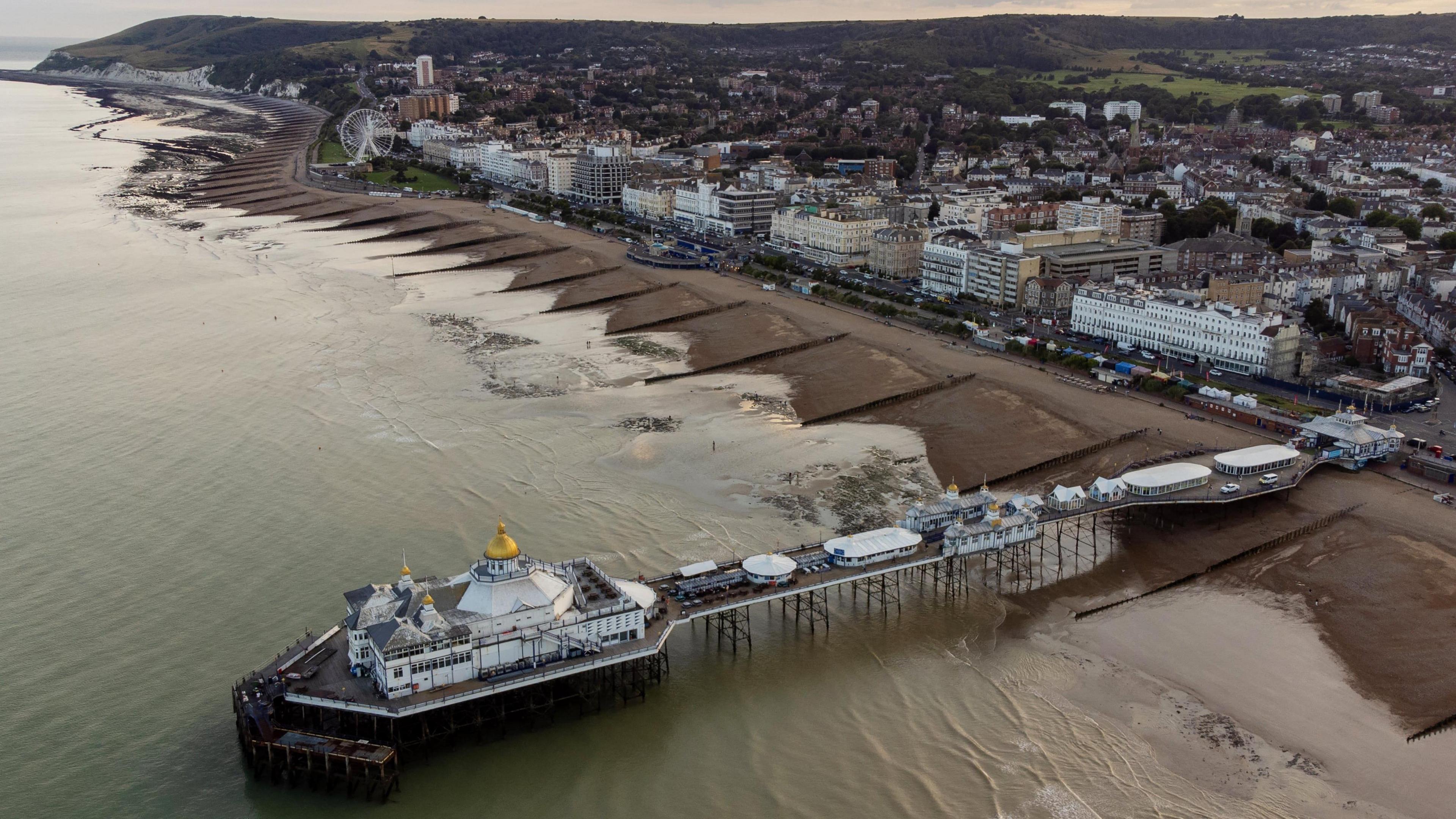 An aerial view over Eastbourne, its seafront and its pier.