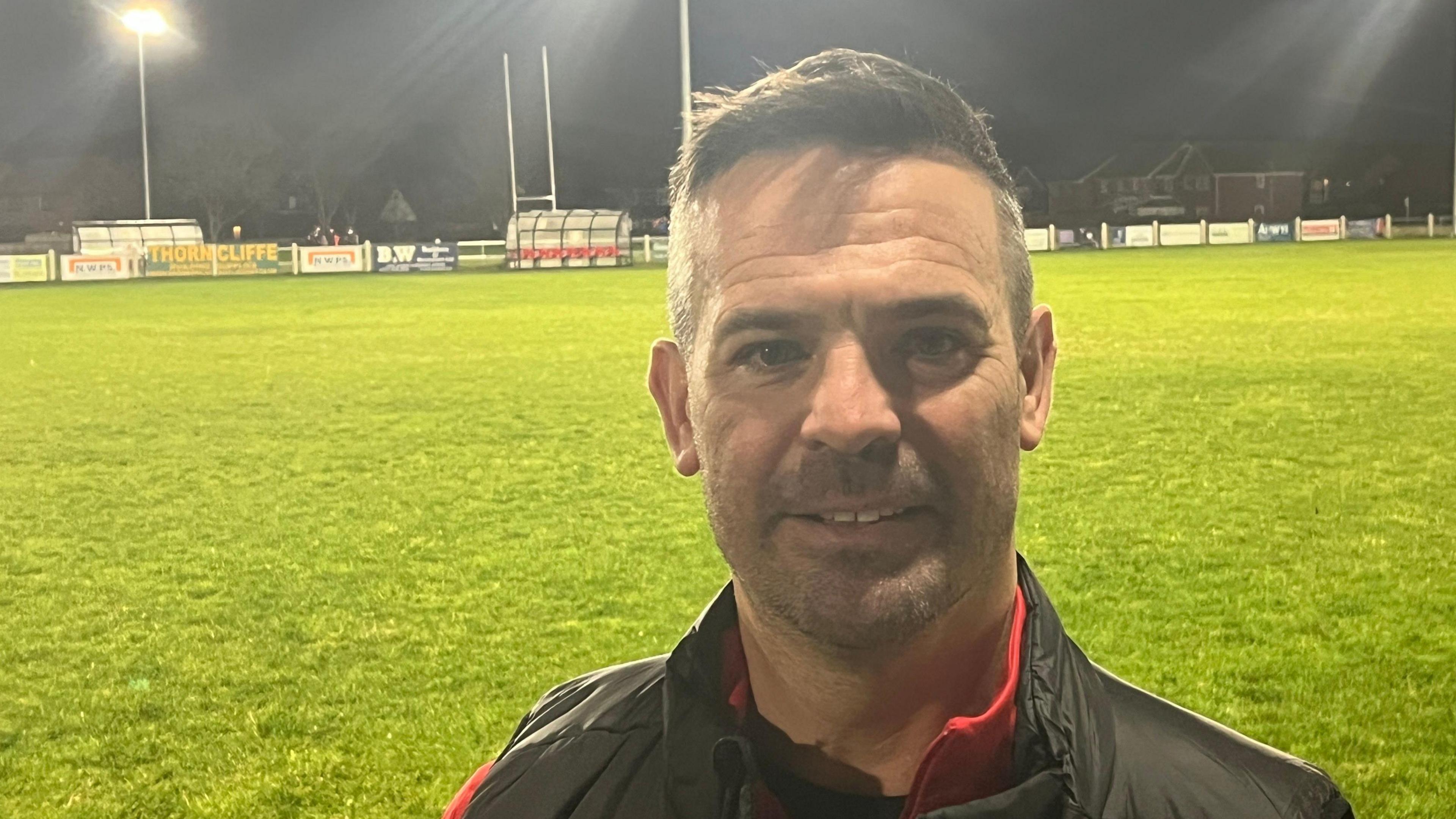 Rhyl Rugby Club chairman Gareth John standing on the club's pitch.