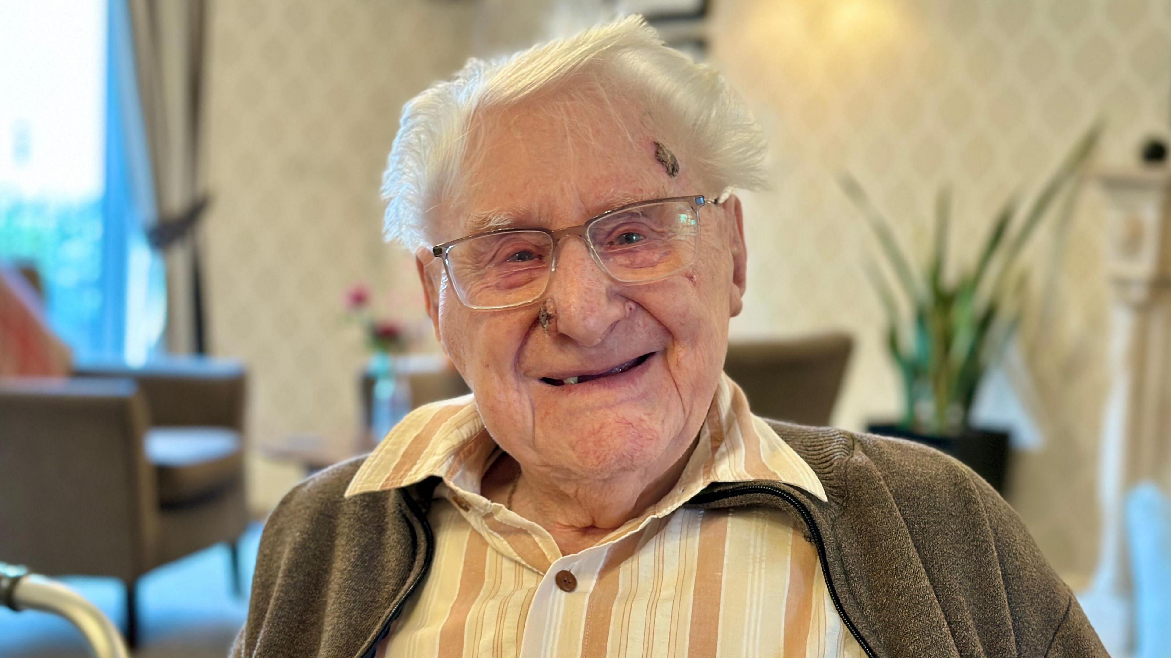 A headshot of Eric Page who is wearing square-framed eye glasses and a shirt.