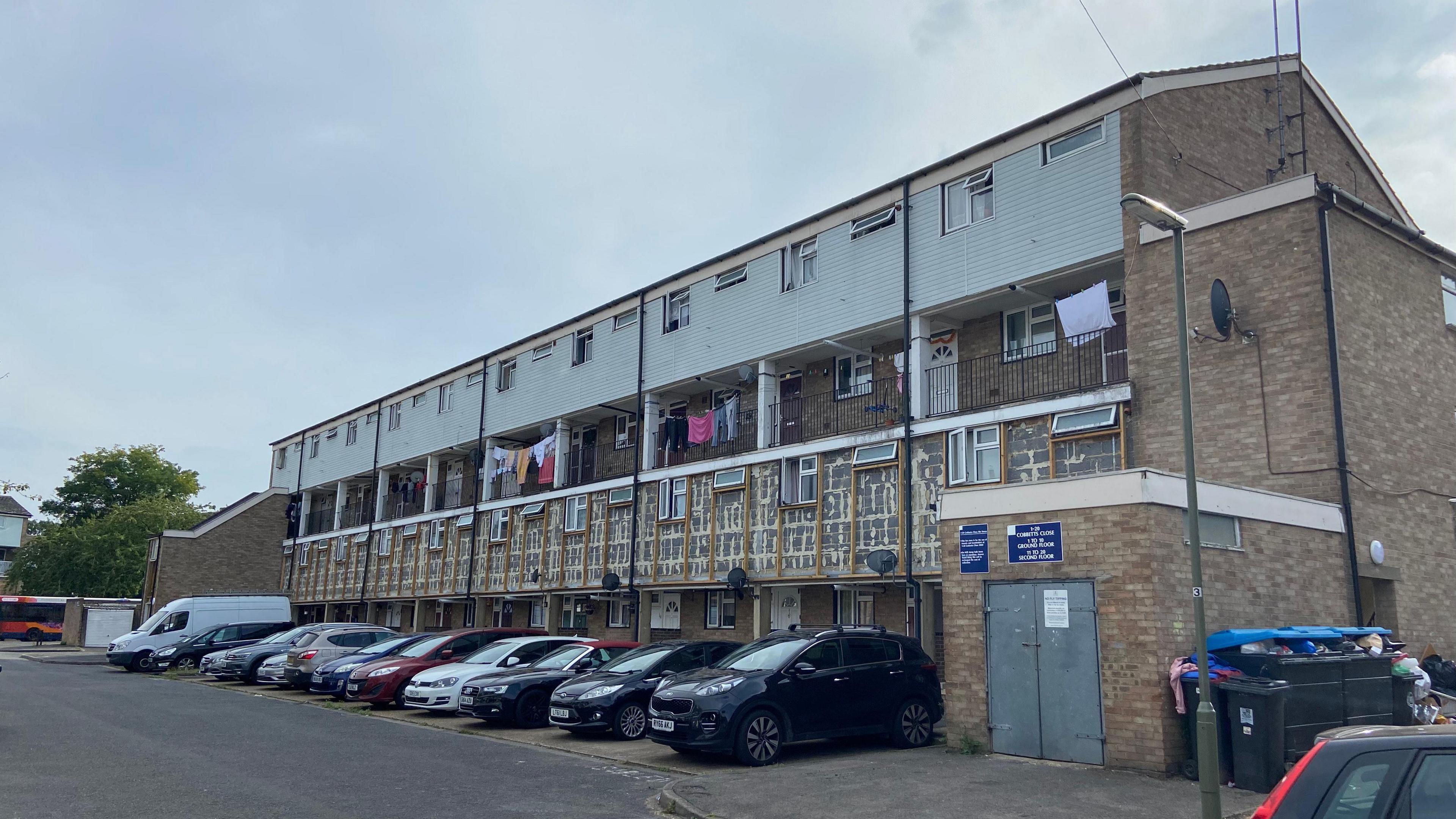 The outside of a building on the Lakeview estate which shows where the external cladding has been removed on a lower level of the homes