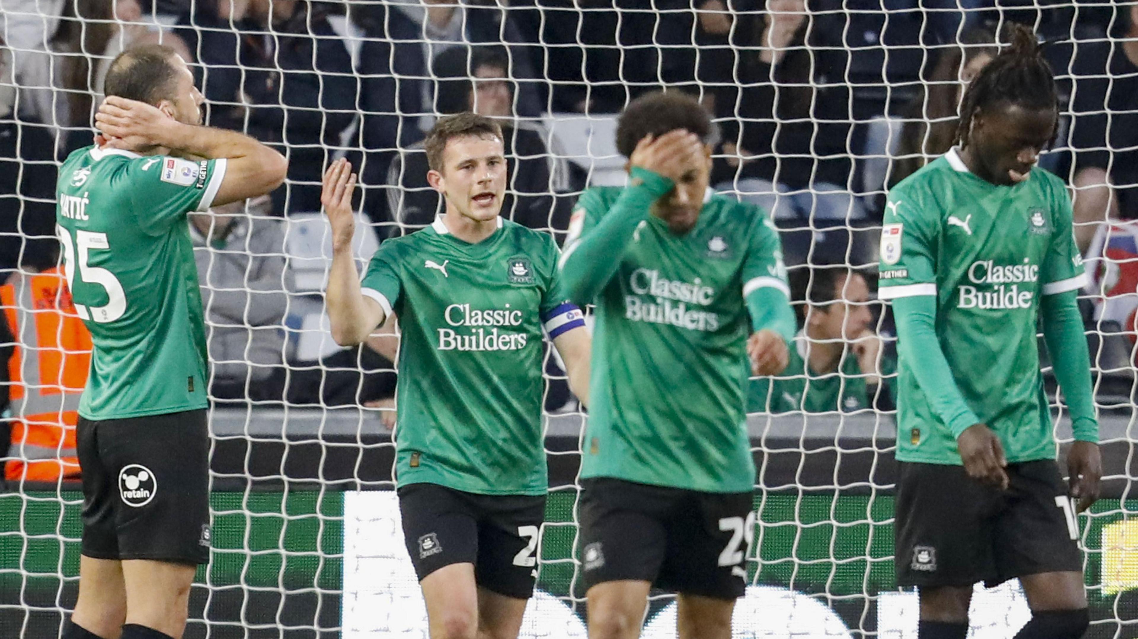 Plymouth Argyle players look upset after conceding a goal