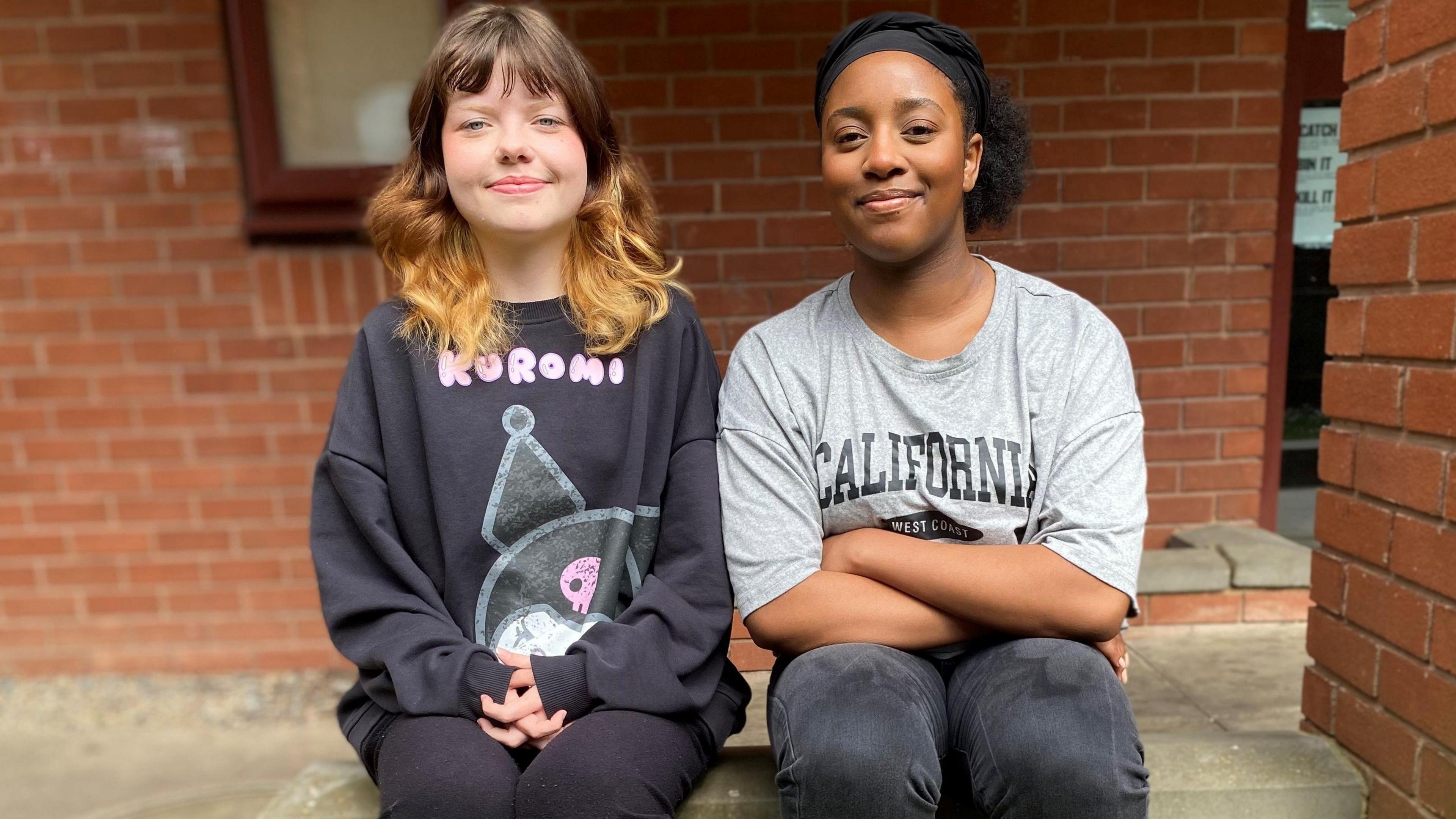 Charlie and Hannah sitting on a step together