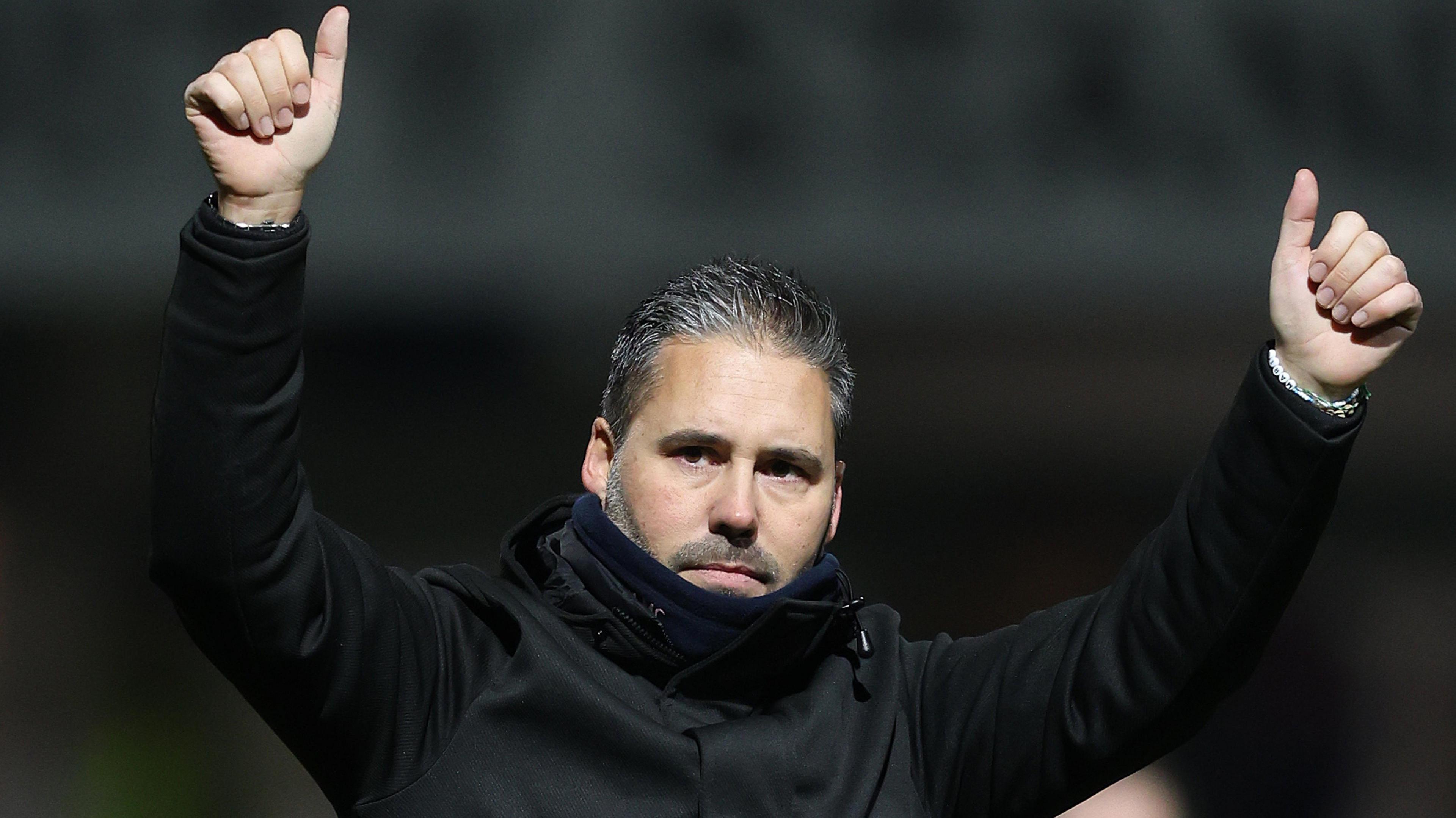 Martin Cifuentes raises both arms into the air and gives a thumbs-up