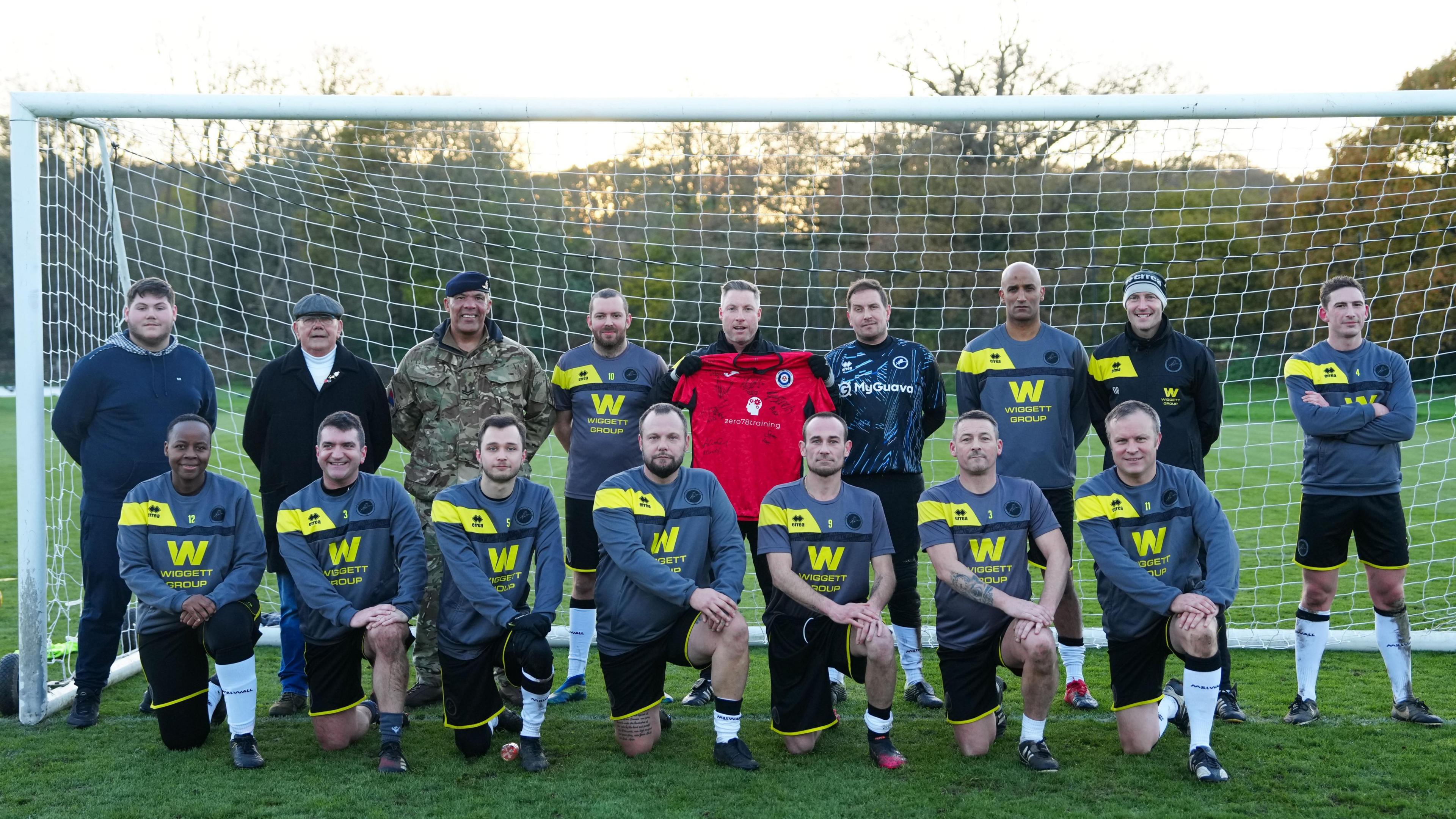 Millwall boss Neil Harris joins military veterans for a football coaching session at the Lions training ground