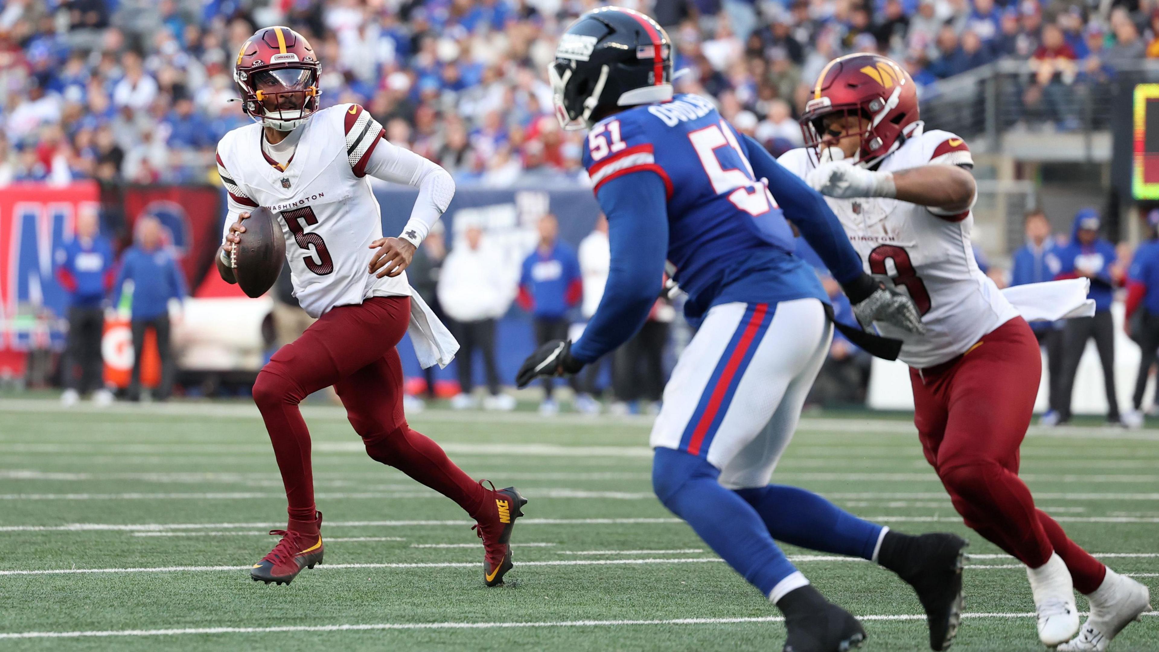 Washington Commanders quarterback Jayden Daniels with the ball against the New York Giants