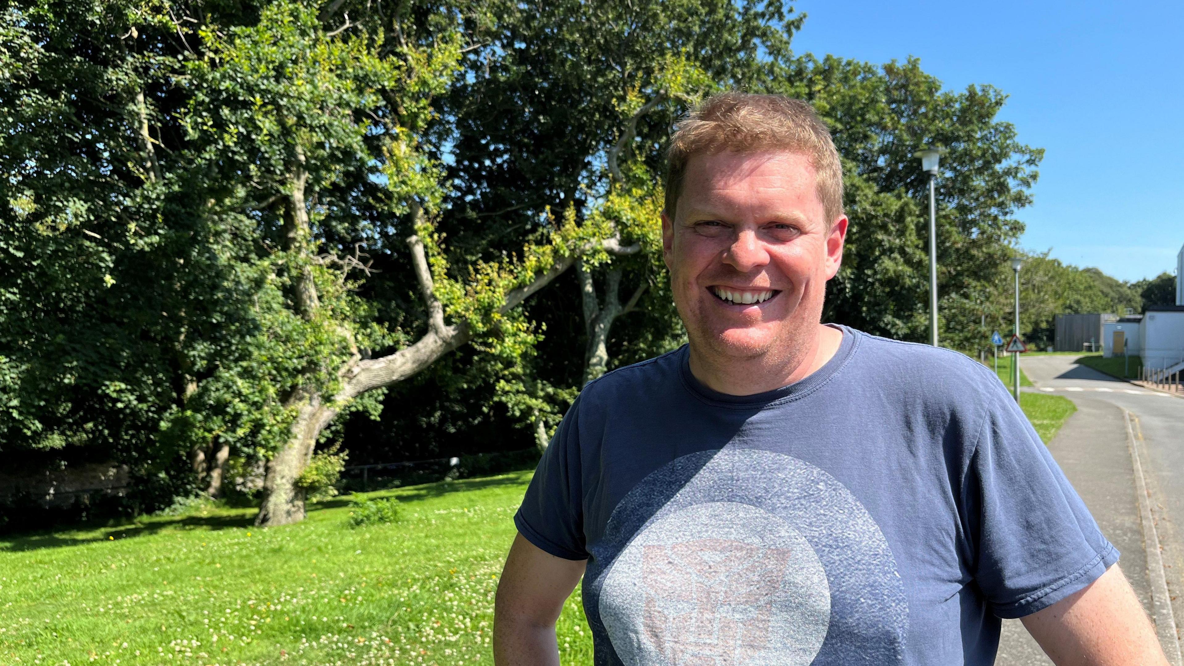 Marc Winn in front of a tree, looking at the camera 