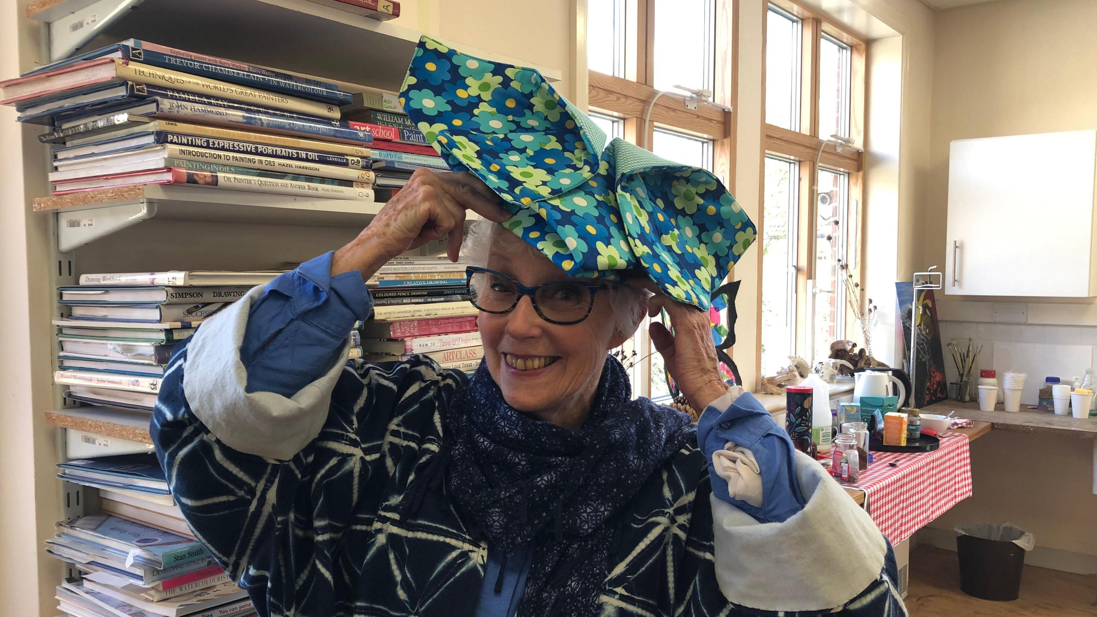 A woman is pictured with colourful fabric on her head