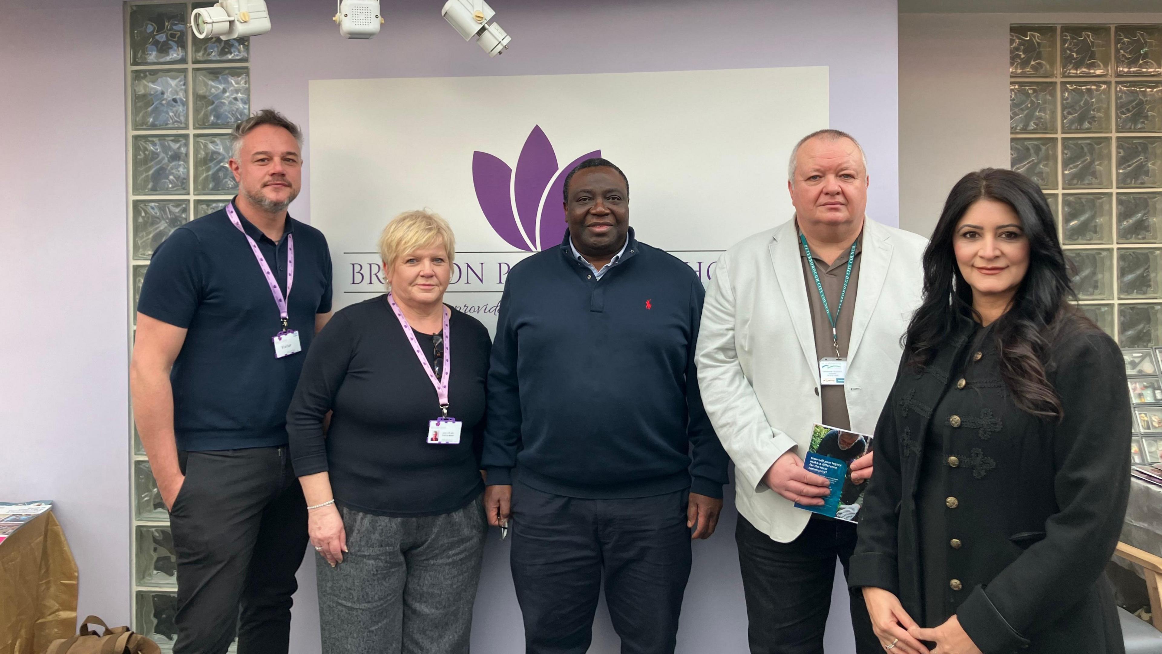 Staff from the Bretton practice - Jason wearing a blue T-shirt, Jackie wearing a black jumper and a purple lanyard, practice partner Dr Mark in a navy blue zipped jumper, councillor Richard in a white blazer and Dr Shabina in a black coat with gold buttons.