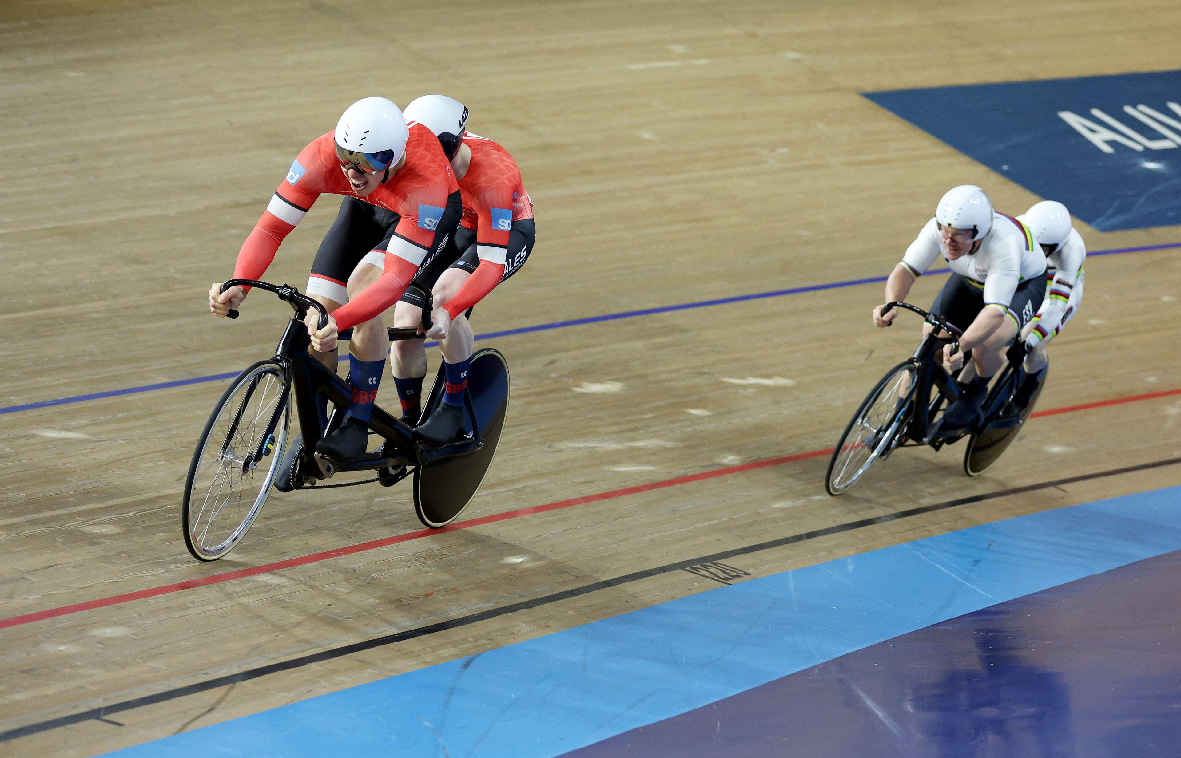 James Ball rides behind pilot Steff Lloyd on the track