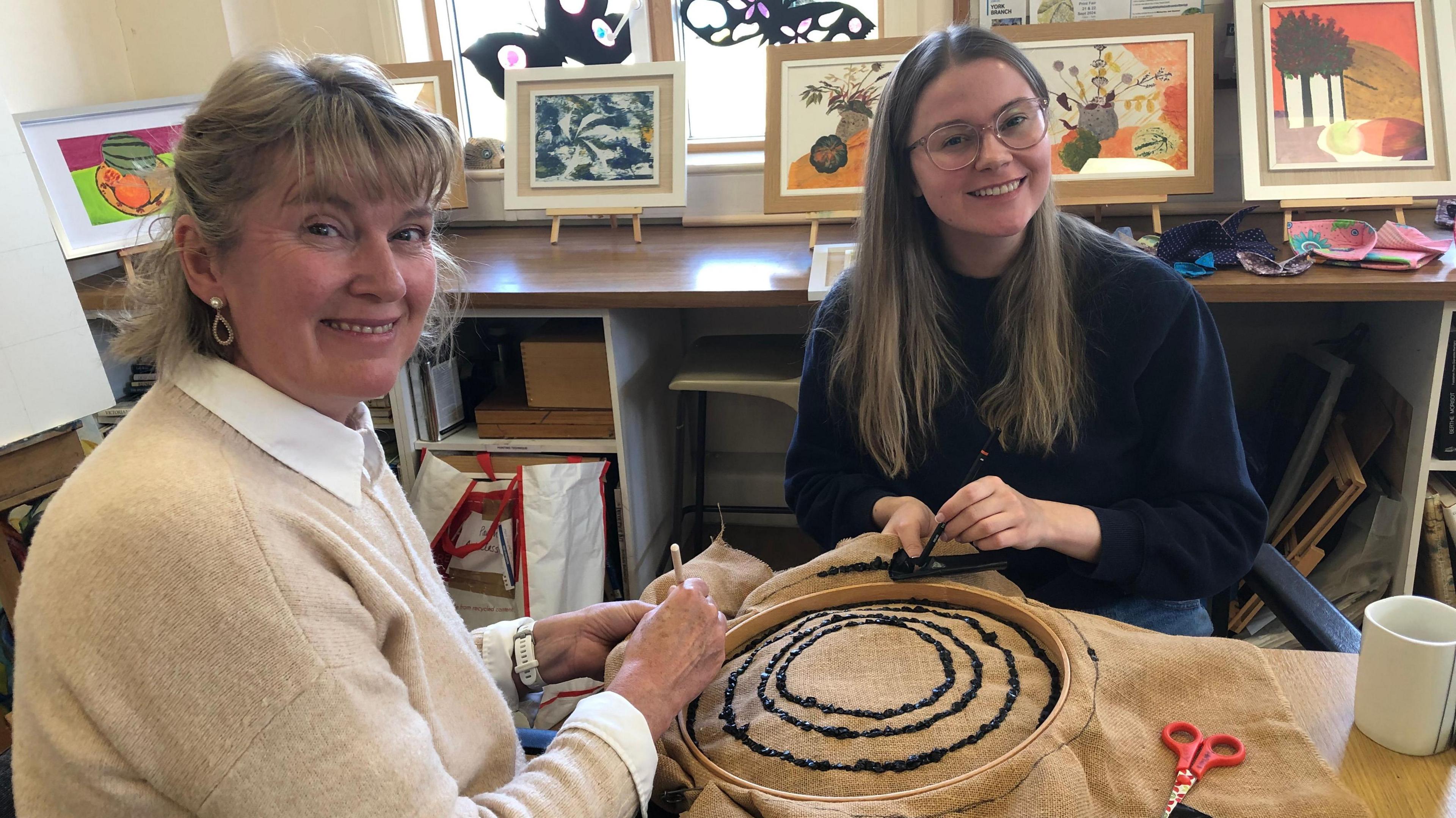 Mel and Ella Spanton are pictured with some hessian cloth