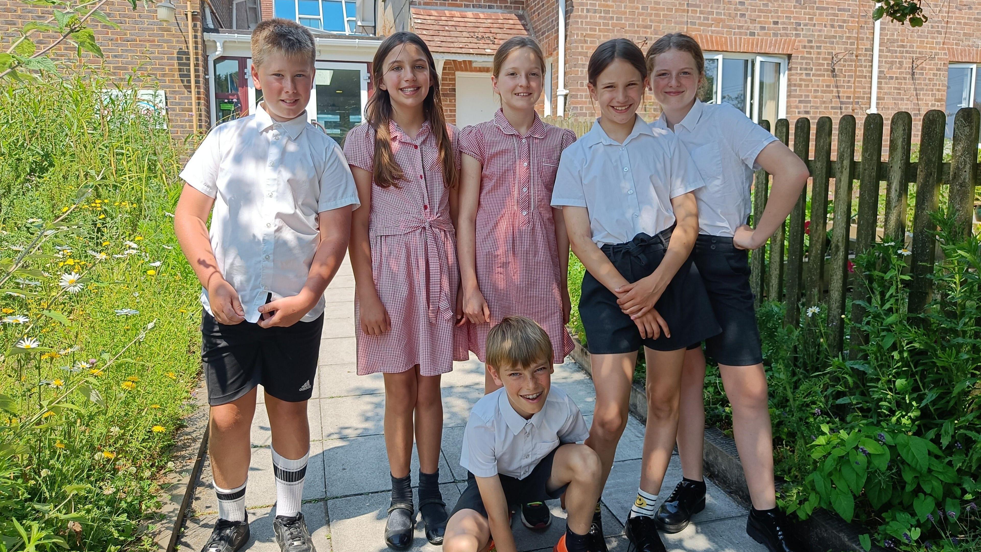 Six students stood outside the school building