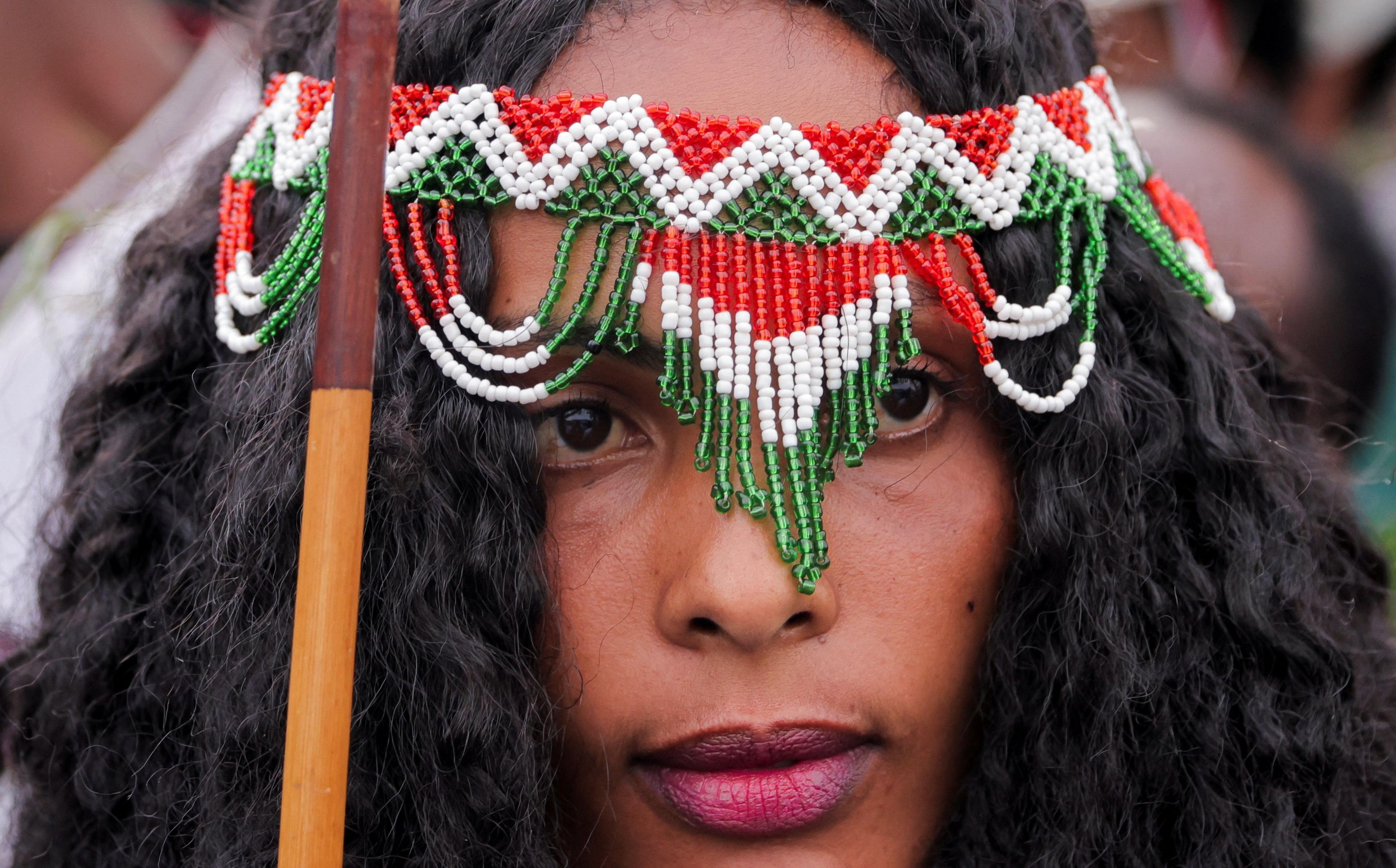 A woman dressed in a traditional Oromo costume attends the Irreecha celebration, the Oromo people's thanksgiving festival at Hora Arsadi in Bishoftu.