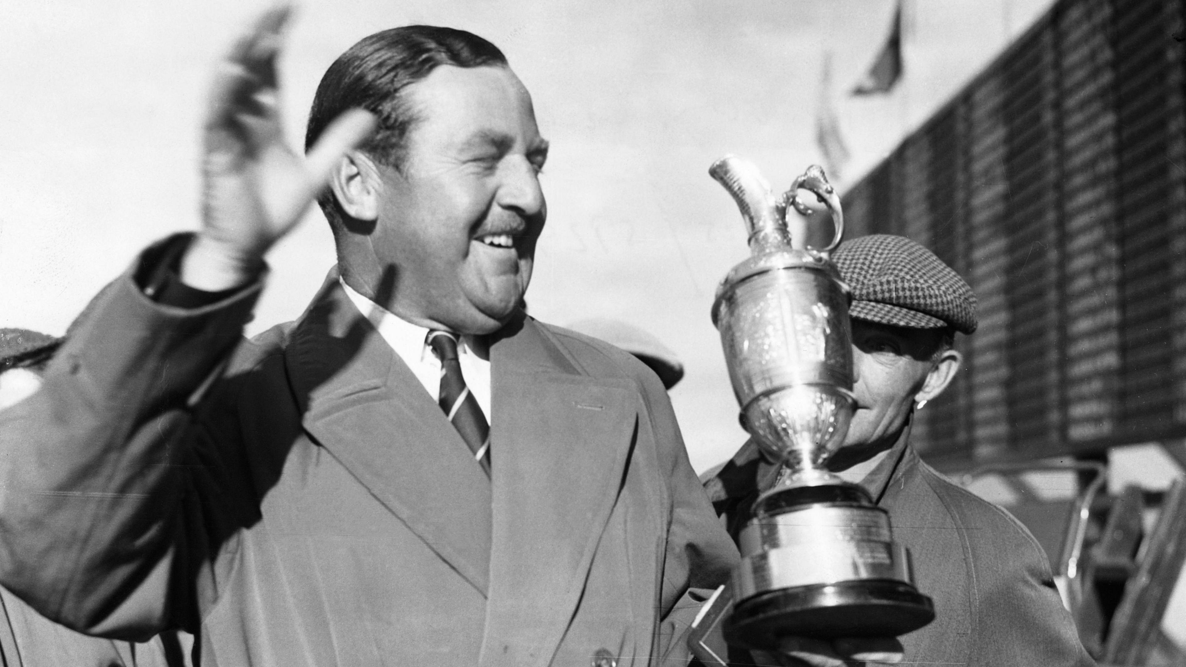 Bobby Locke waves to the crowd while holding the Open trophy