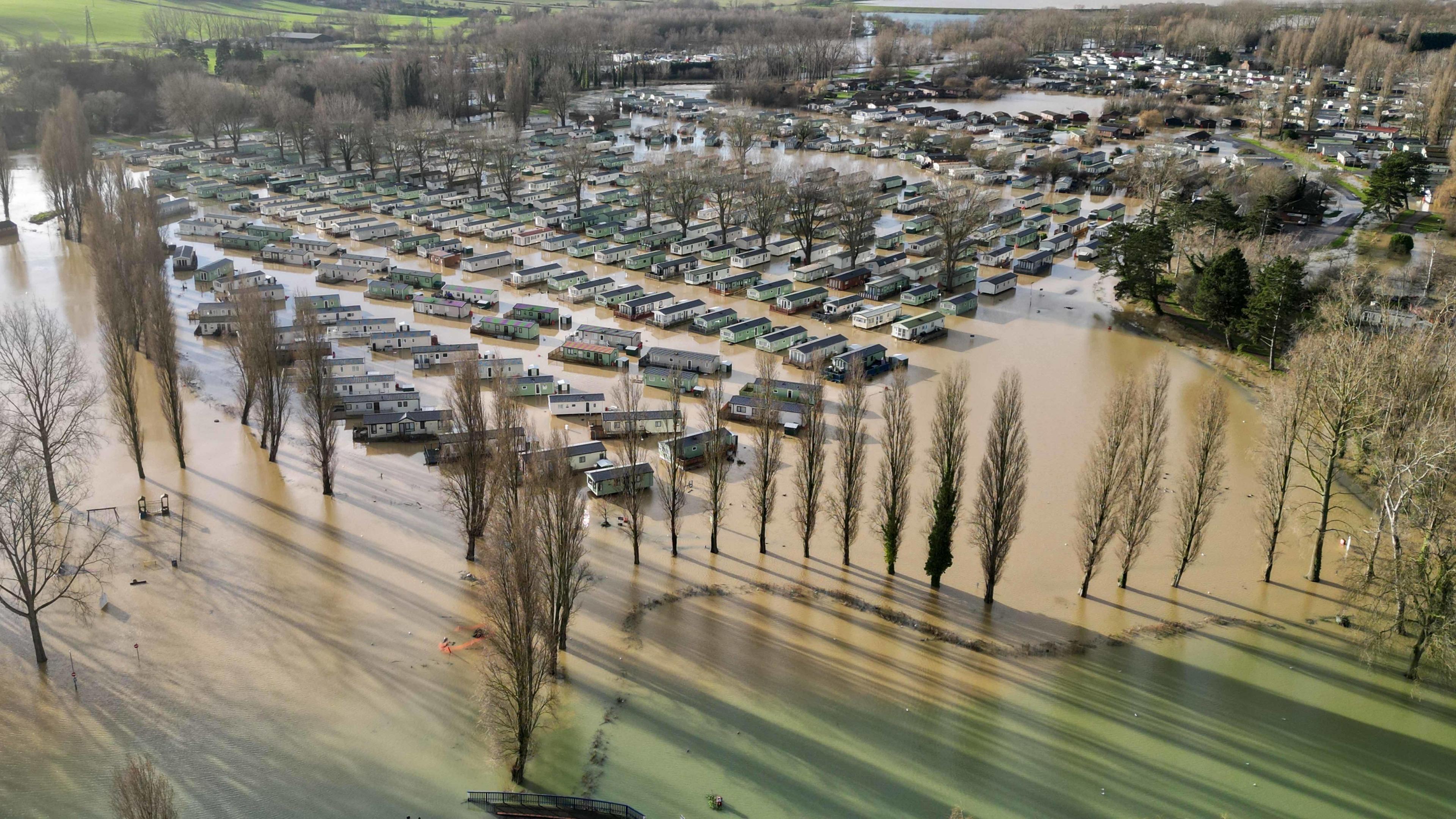 Holiday homes at Billing Aquadrome surrounded by water after Storm Henk in 2024