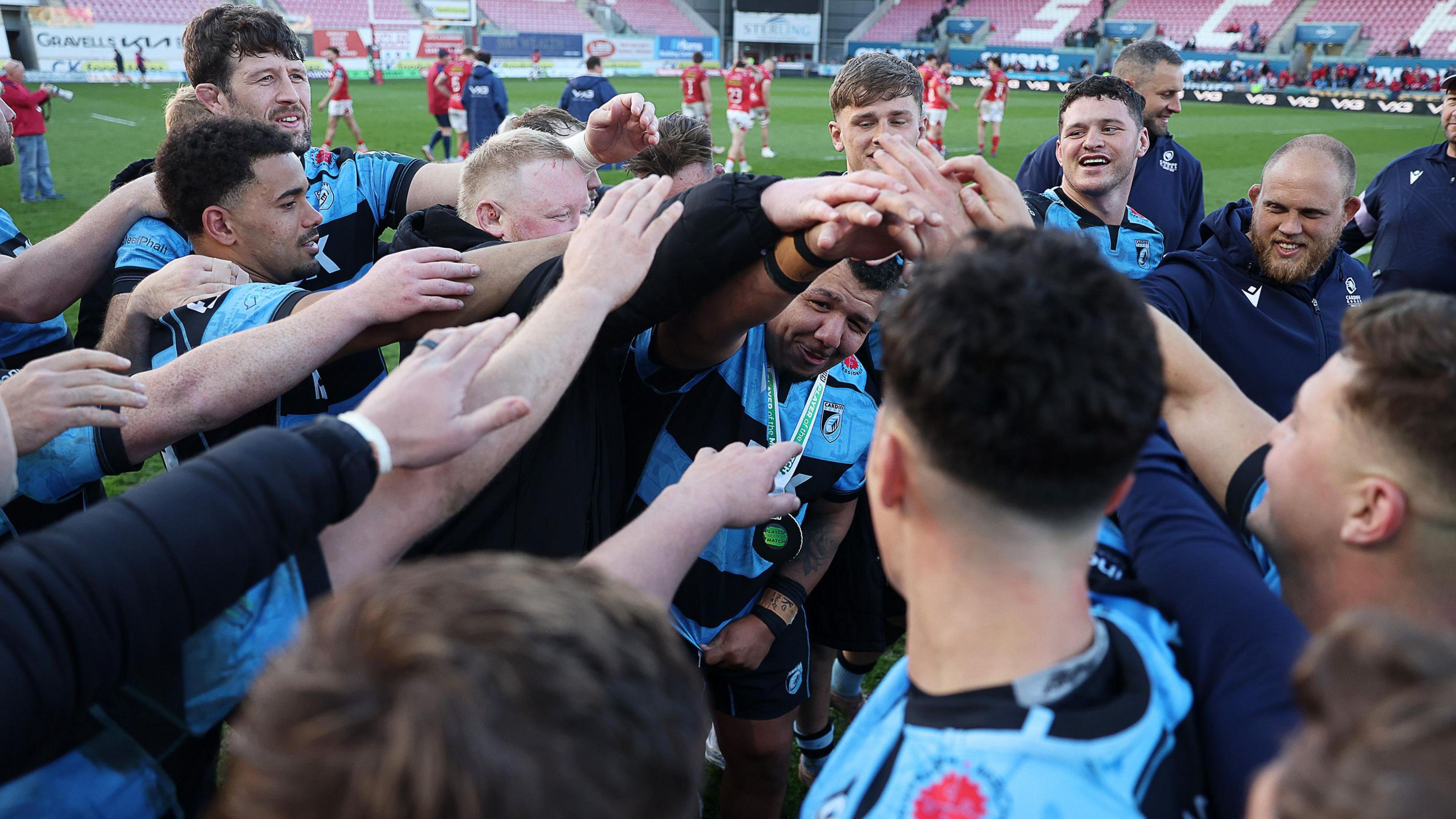 Cardiff players in a triumphant huddle after beating Scarlets in Aril 2026