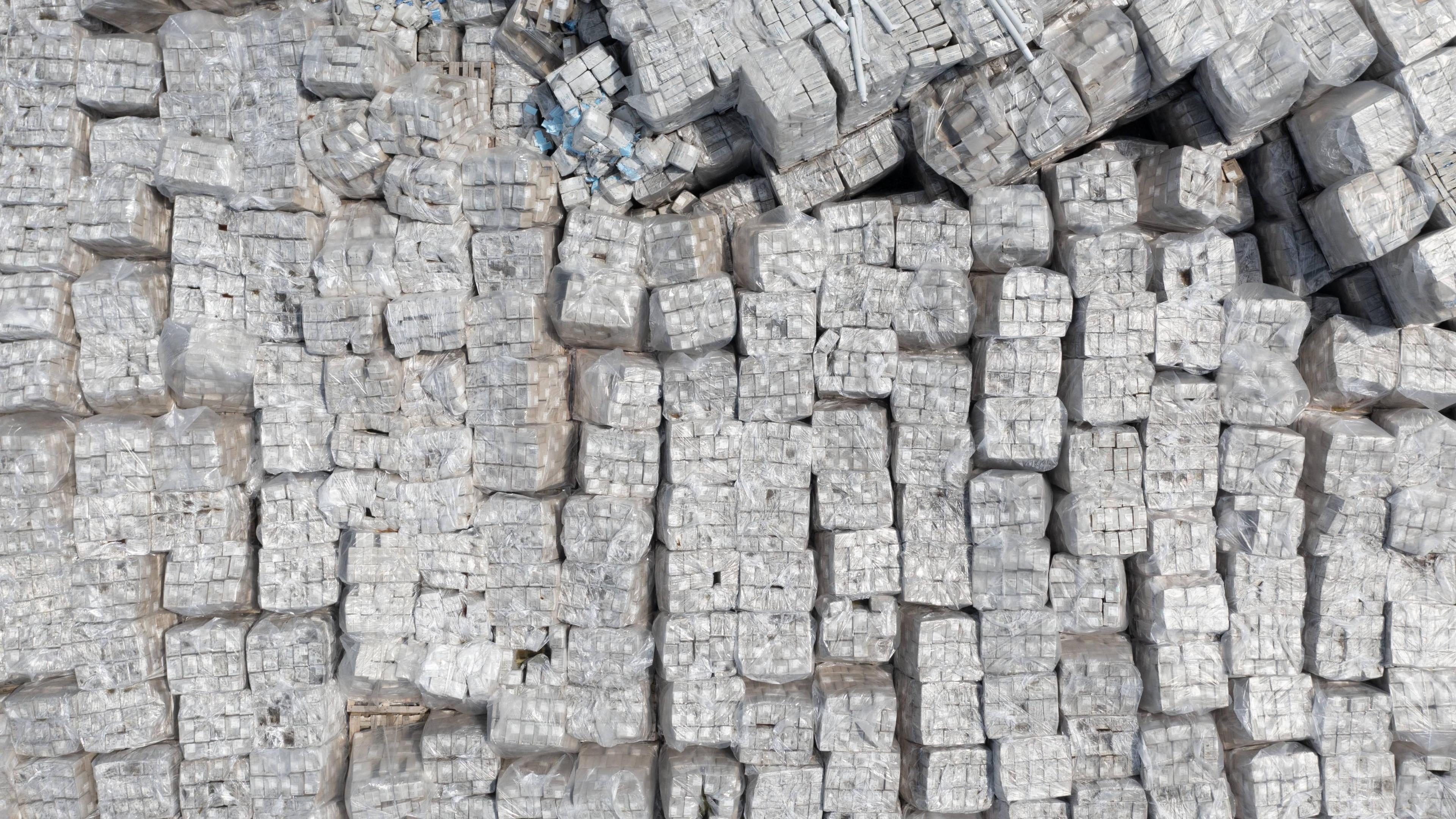 An aerial view of a large amount of Full Support Healthcare PPE dumped at a site