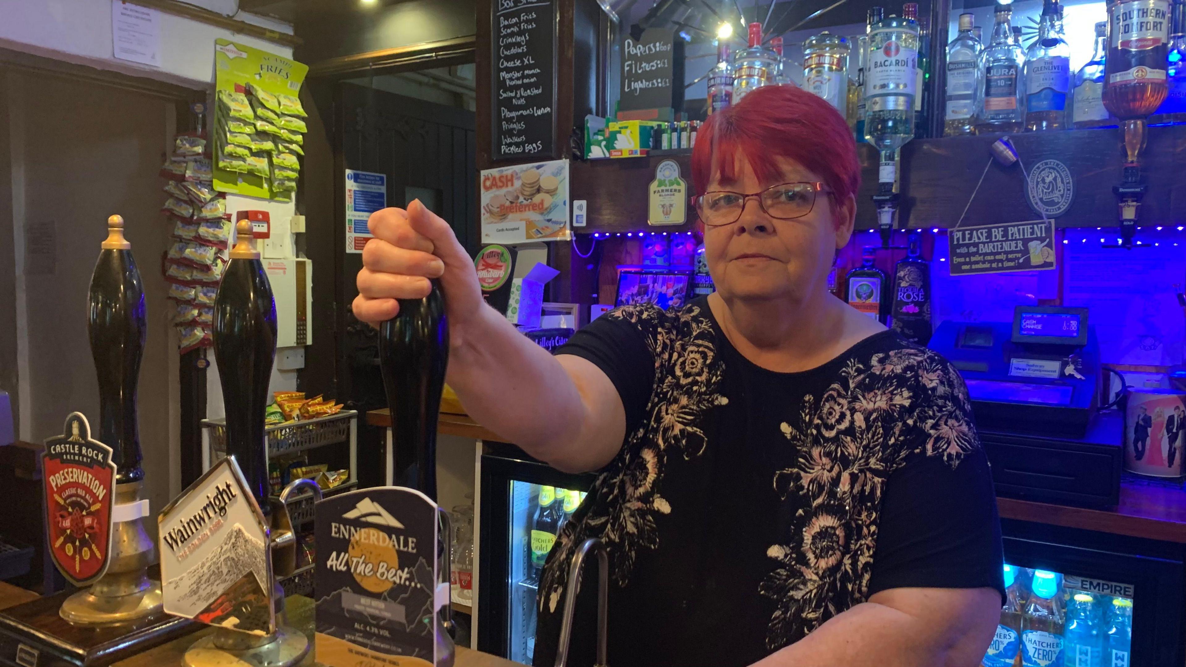 A photograph of Amanda Picken pulling a pint of Ennerdale beer at the Spotsman Inn in Carlisle.